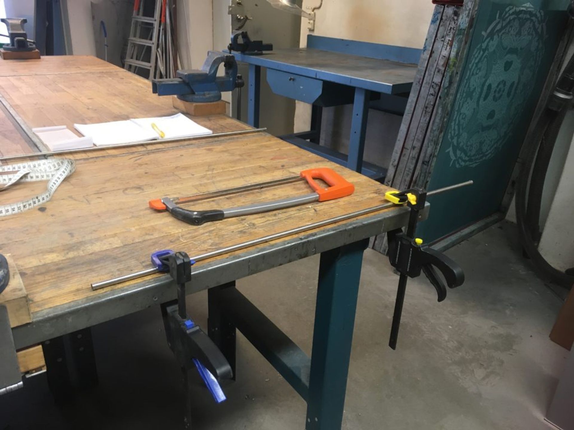 Close-up of a table and saw in a metal workshop.