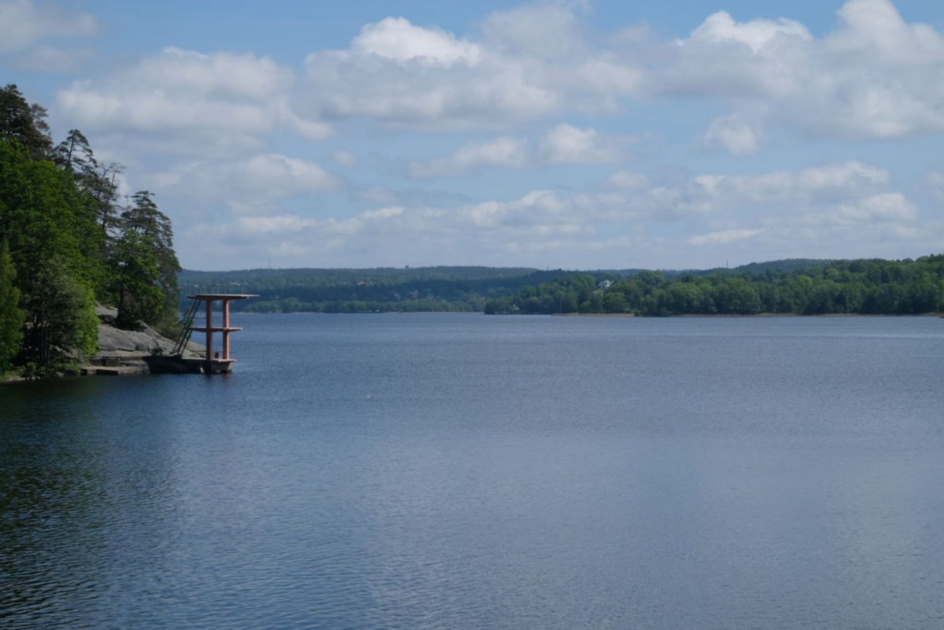 A red diving platform beside the lake.