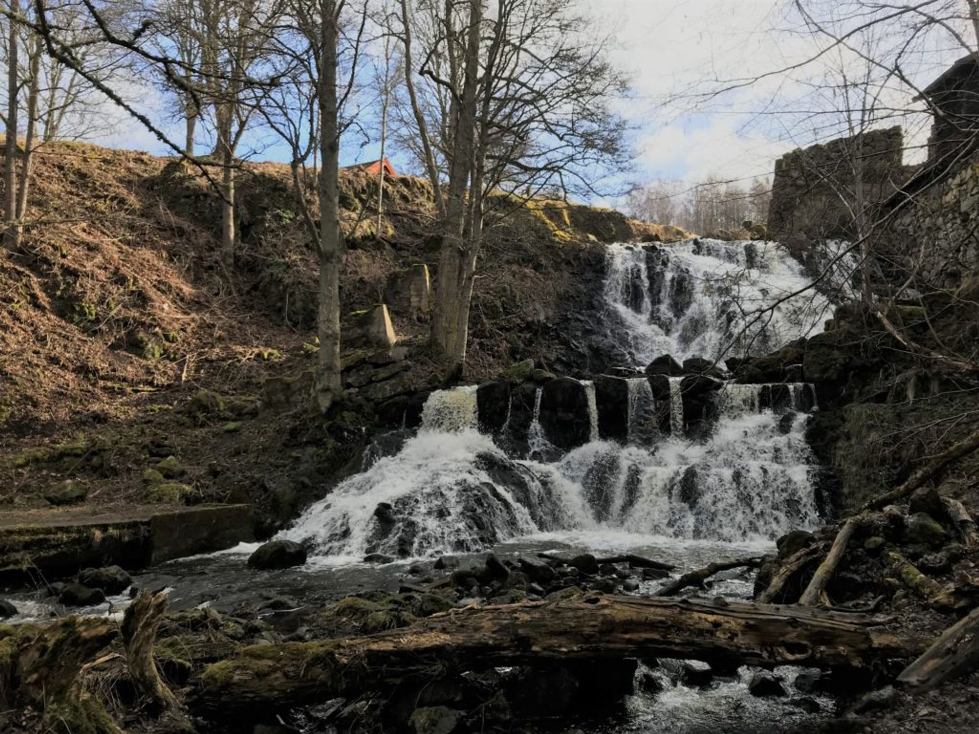 A waterfall beside a mill.