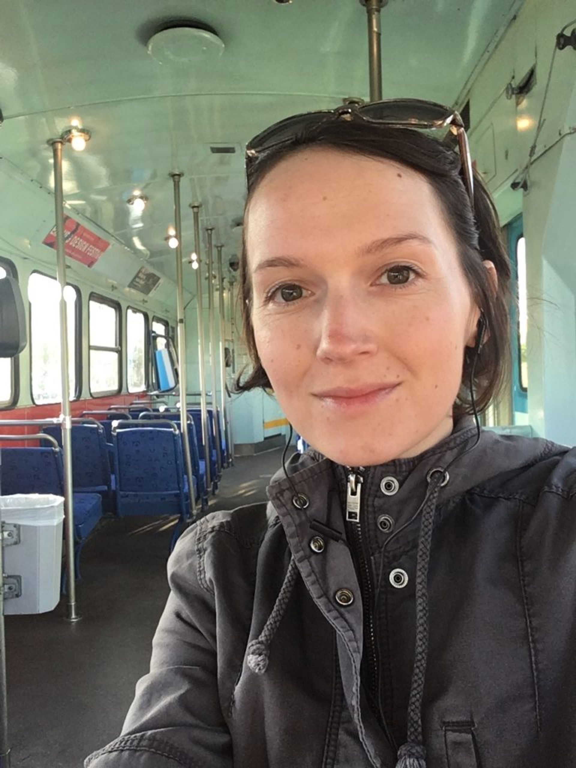 A student taking a selfie on a tram.