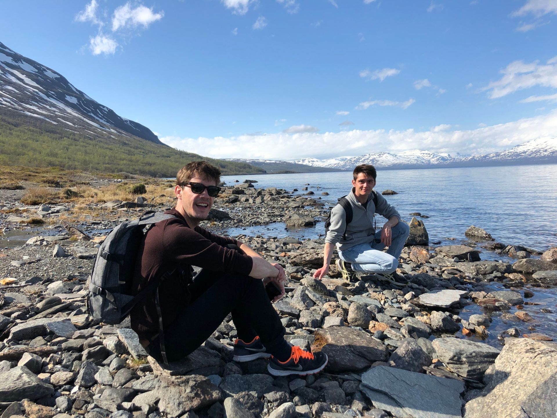 Two friends sitting by a lake in Northern Sweden