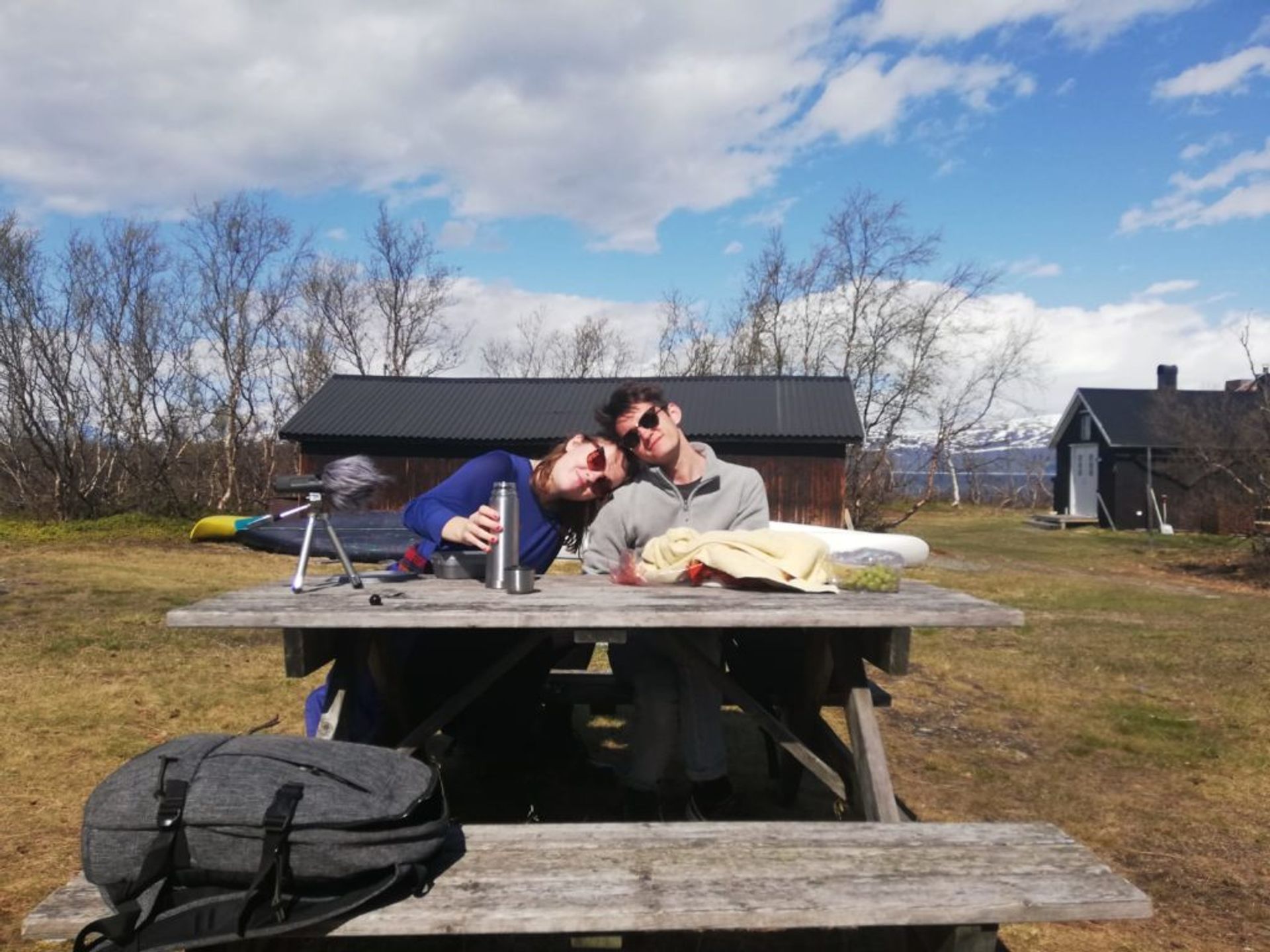 Two students sitting at a picnic bench.