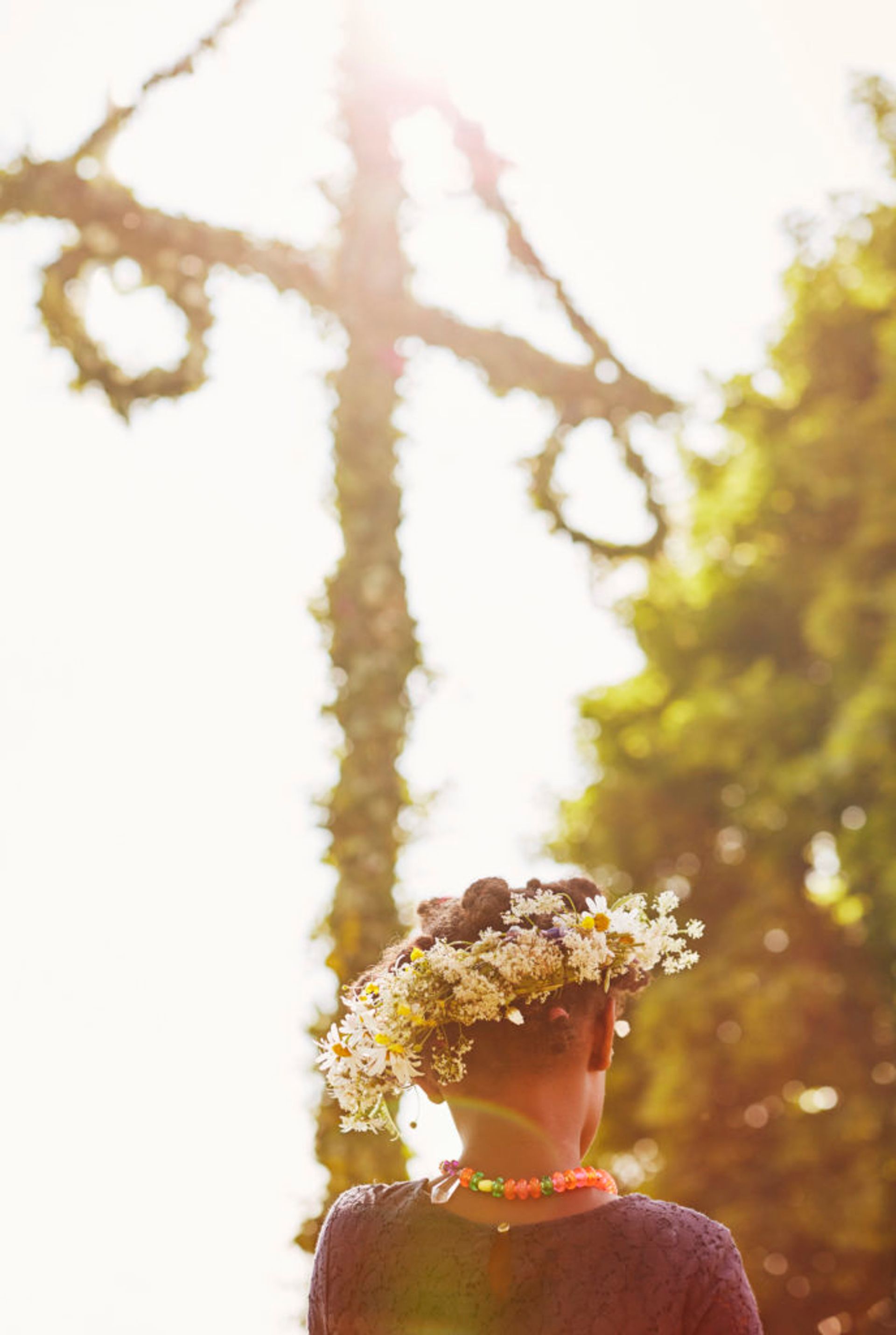 Close-up of a child wearing a flower crown.