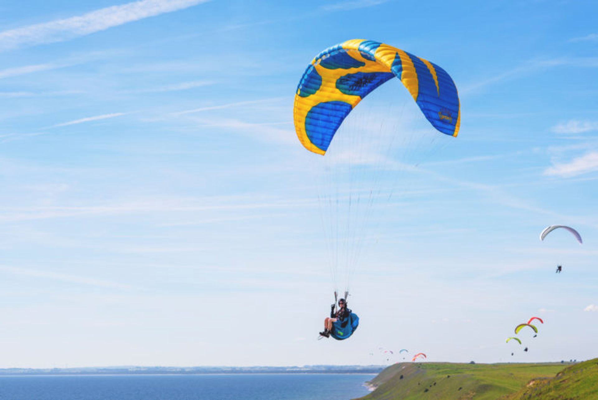 A person hanggliding off a cliff.