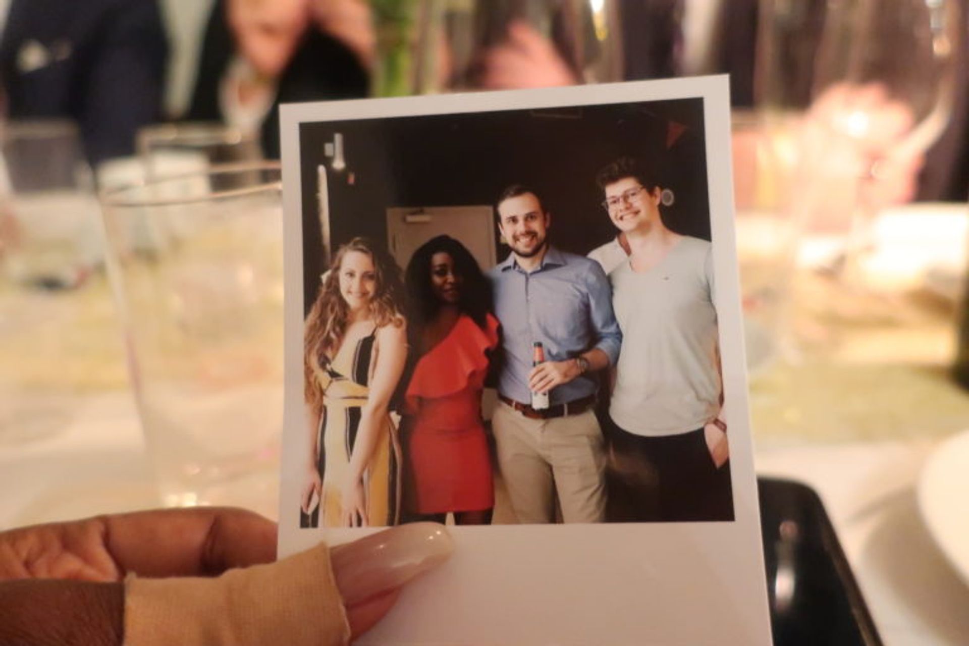 Close-up of a polaroid photo featuring several students.