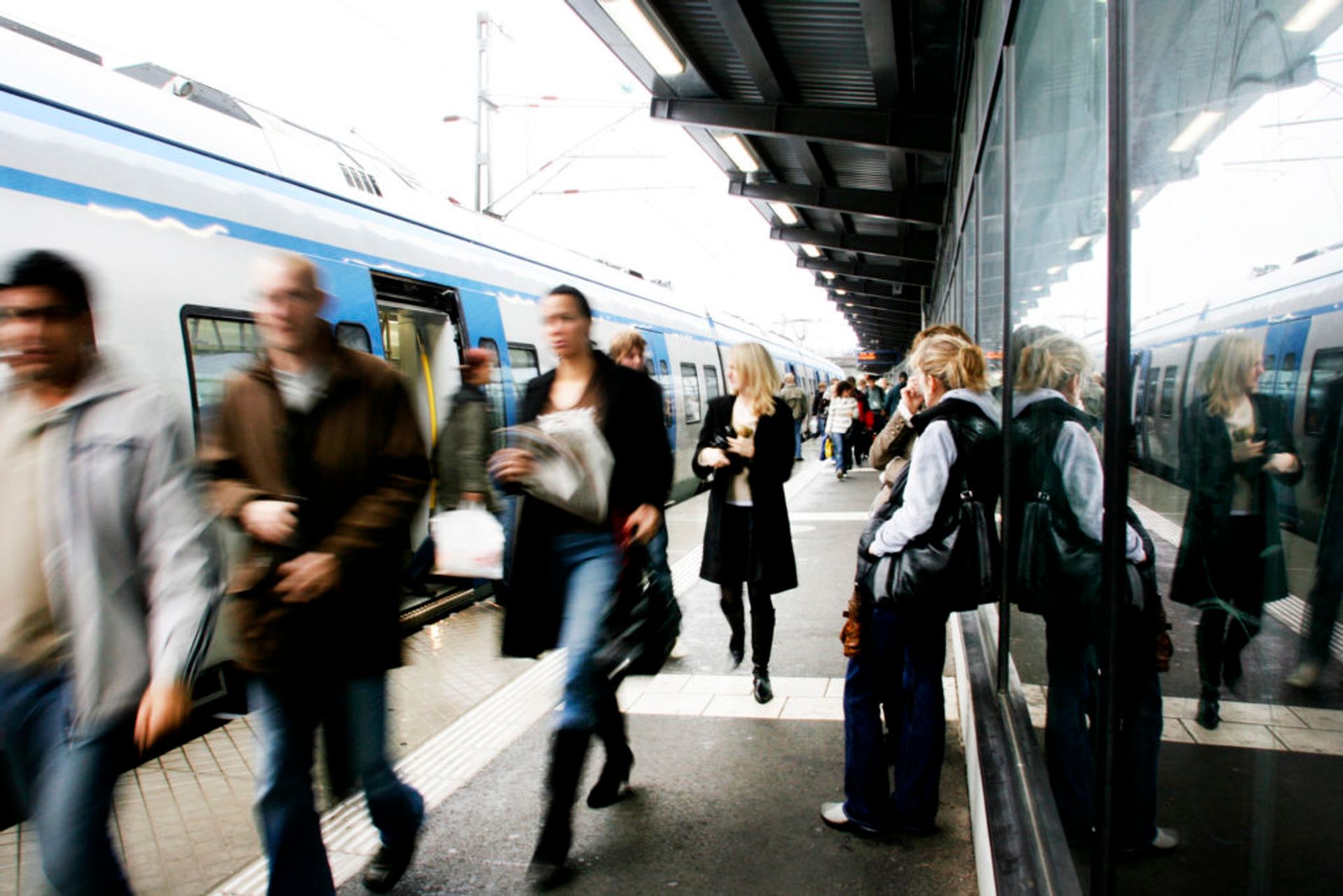 Commuters leaving a train.