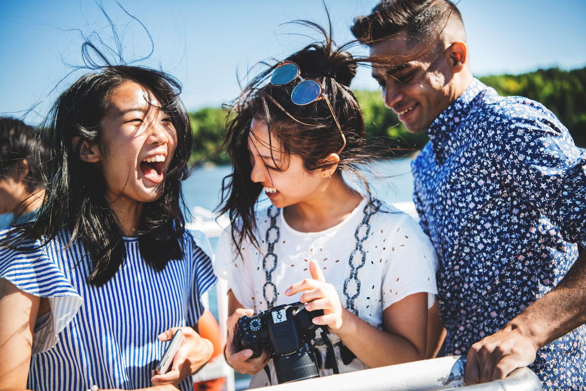 Three students laughing together.