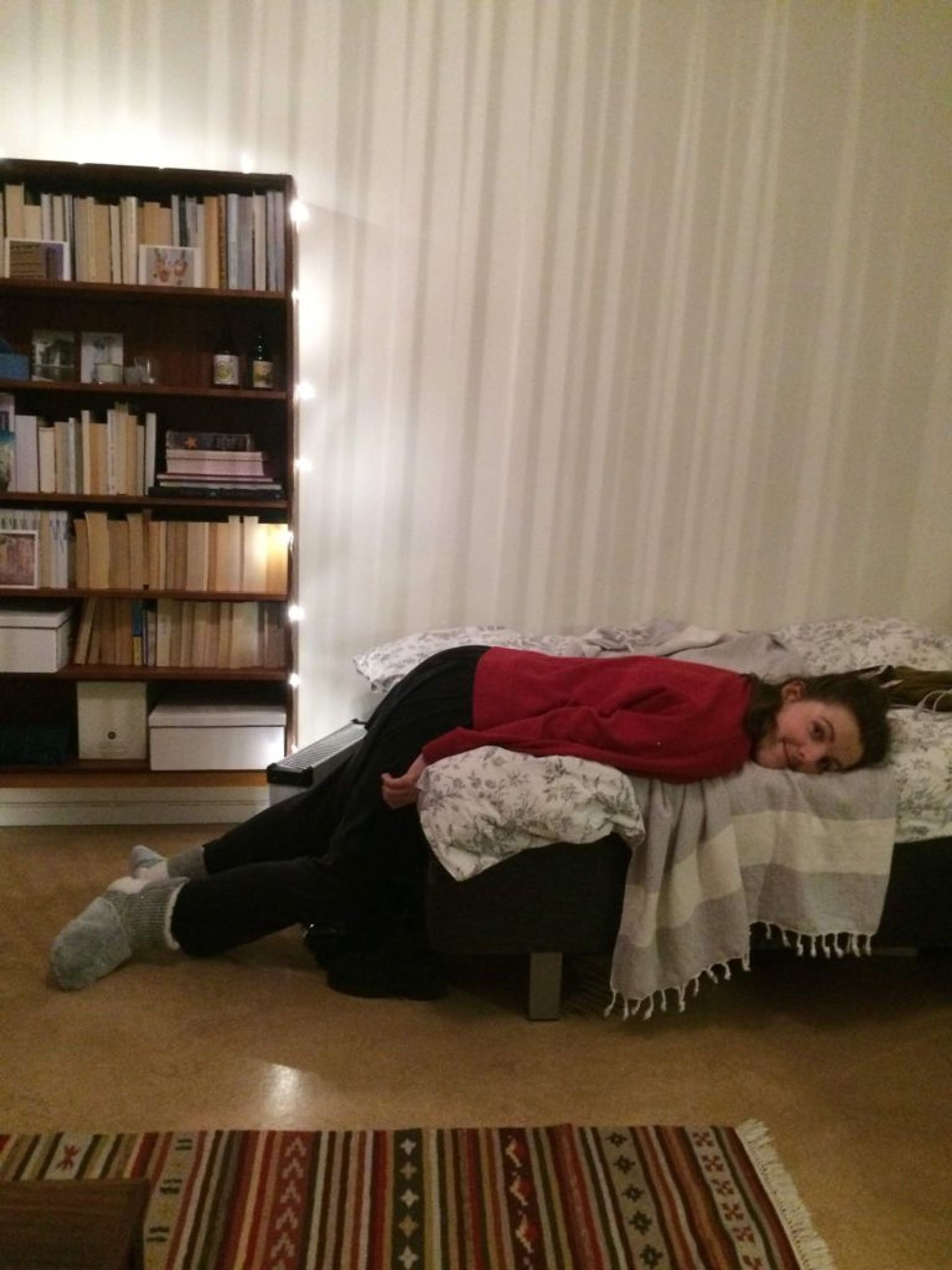 A student lying on a bed.