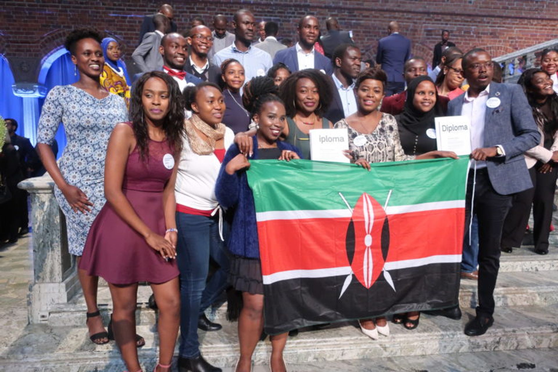 A group of students holding up a Kenyan flag.