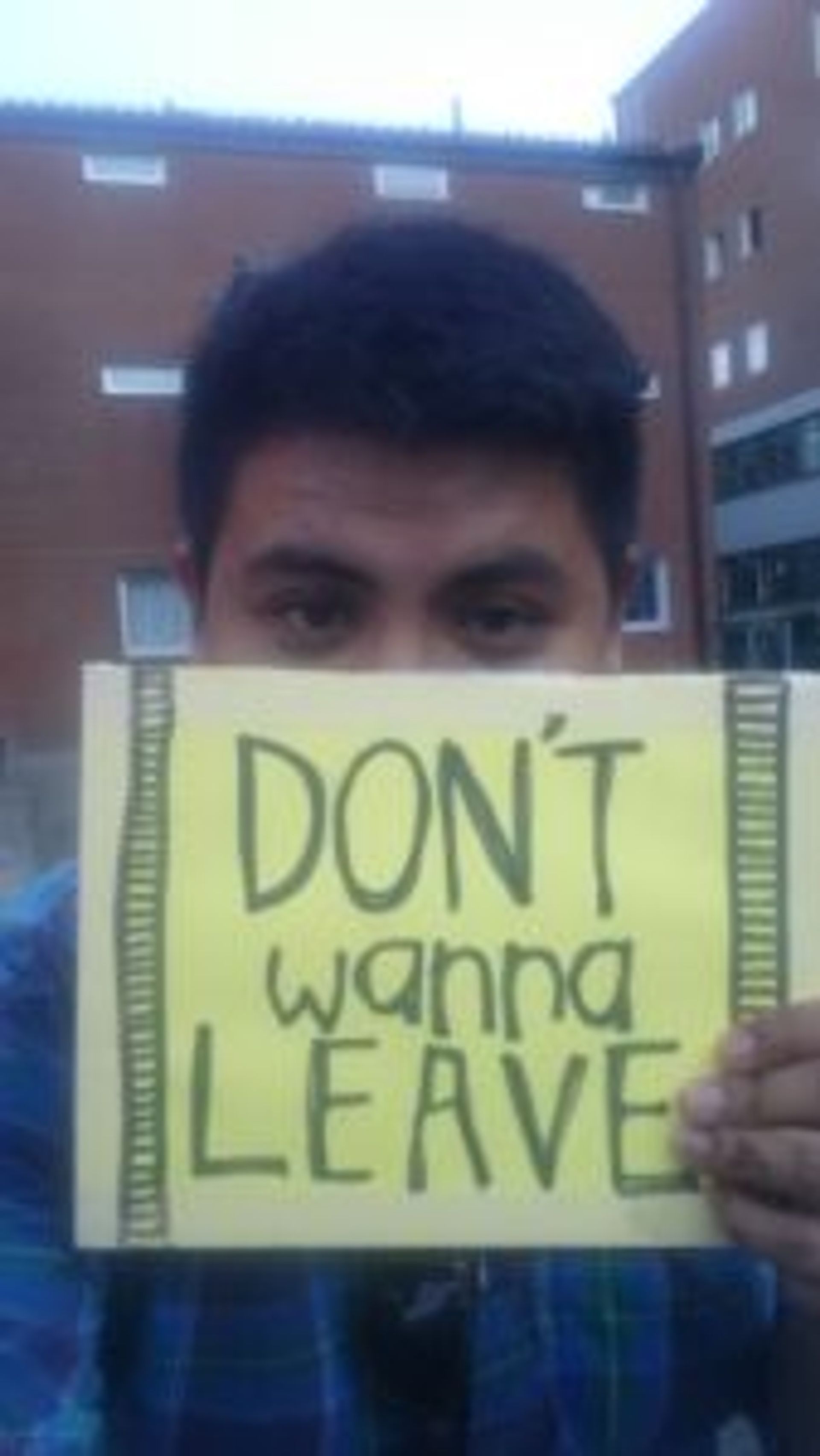 Close-up of sign that reads, 'Don't wanna leave'.