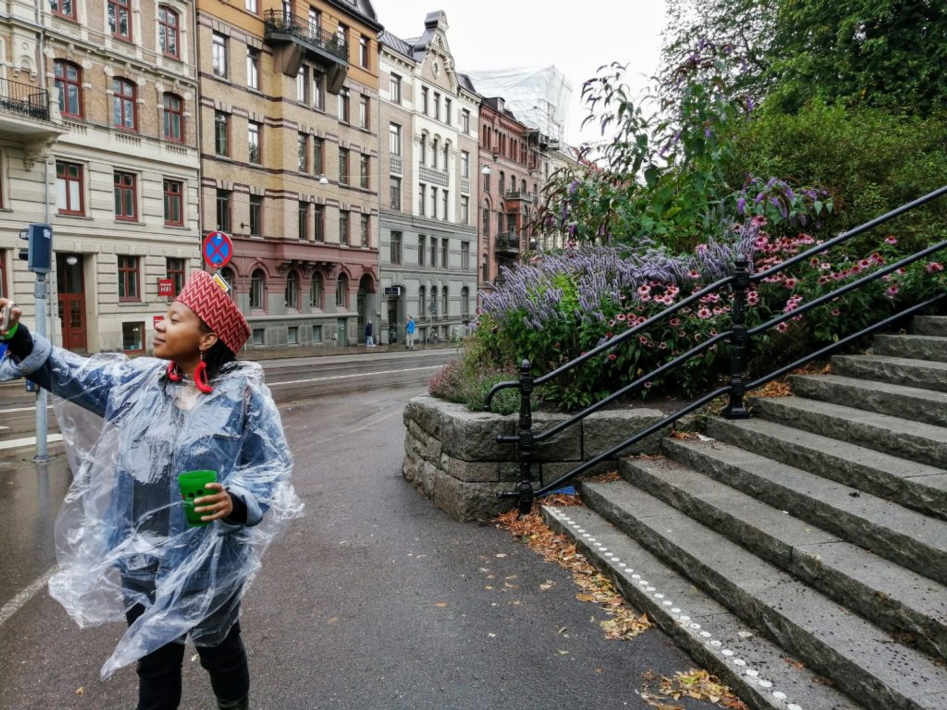 Nthupula taking a rainy selfie in front of a park in Gothenburg