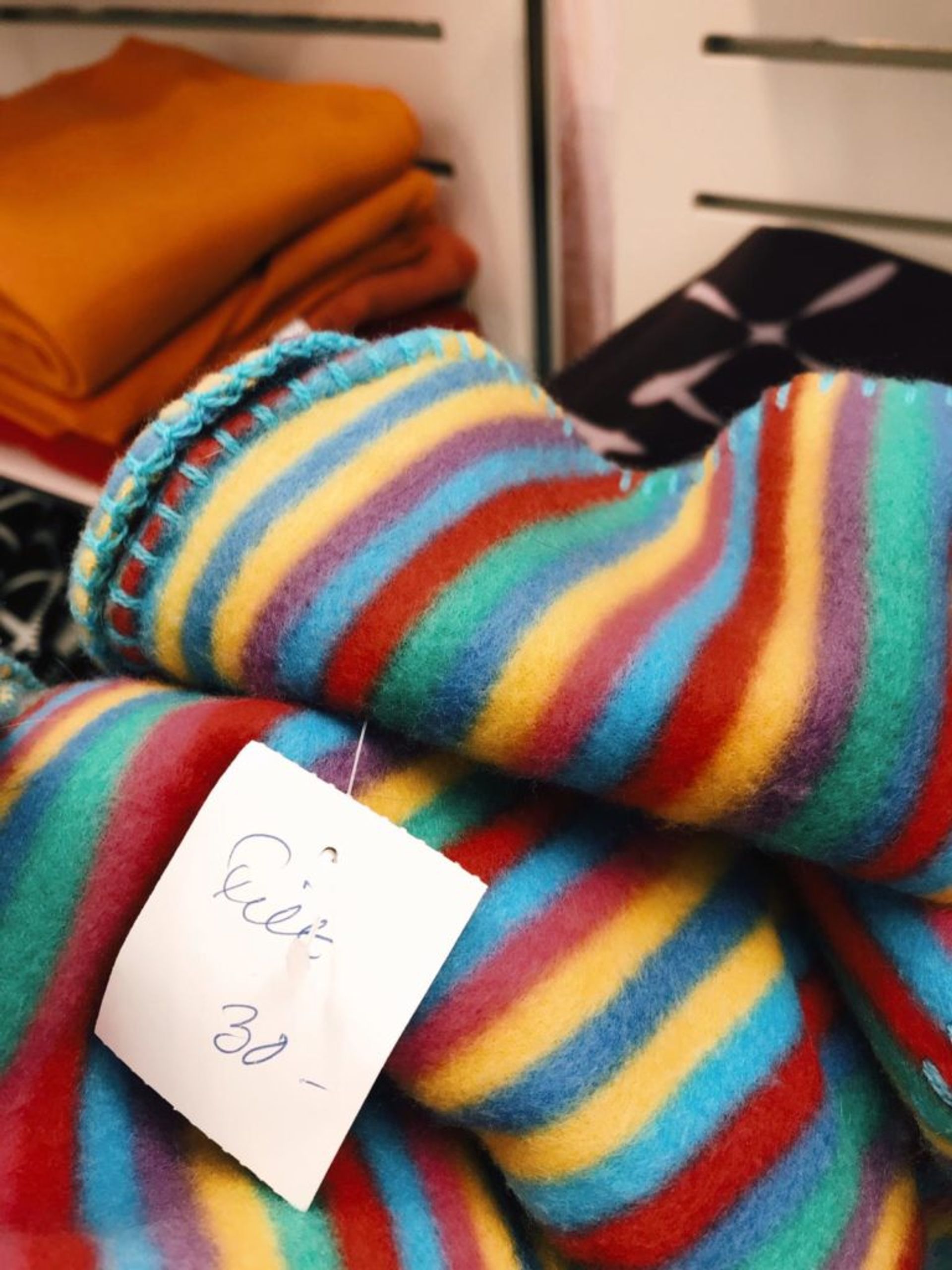 Close-up of a rainbow-coloured blanket.