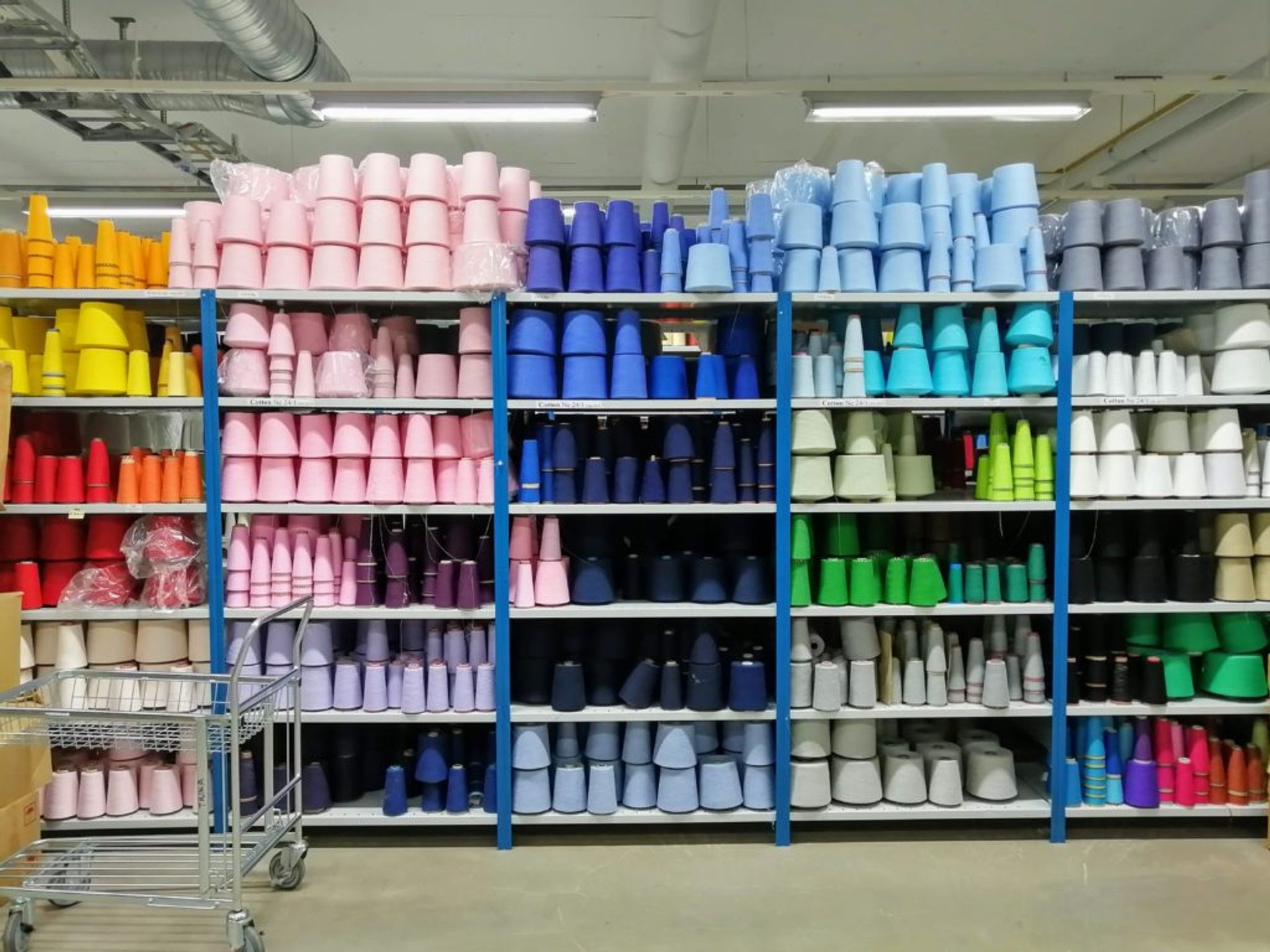 Spools of yarn on shelves.