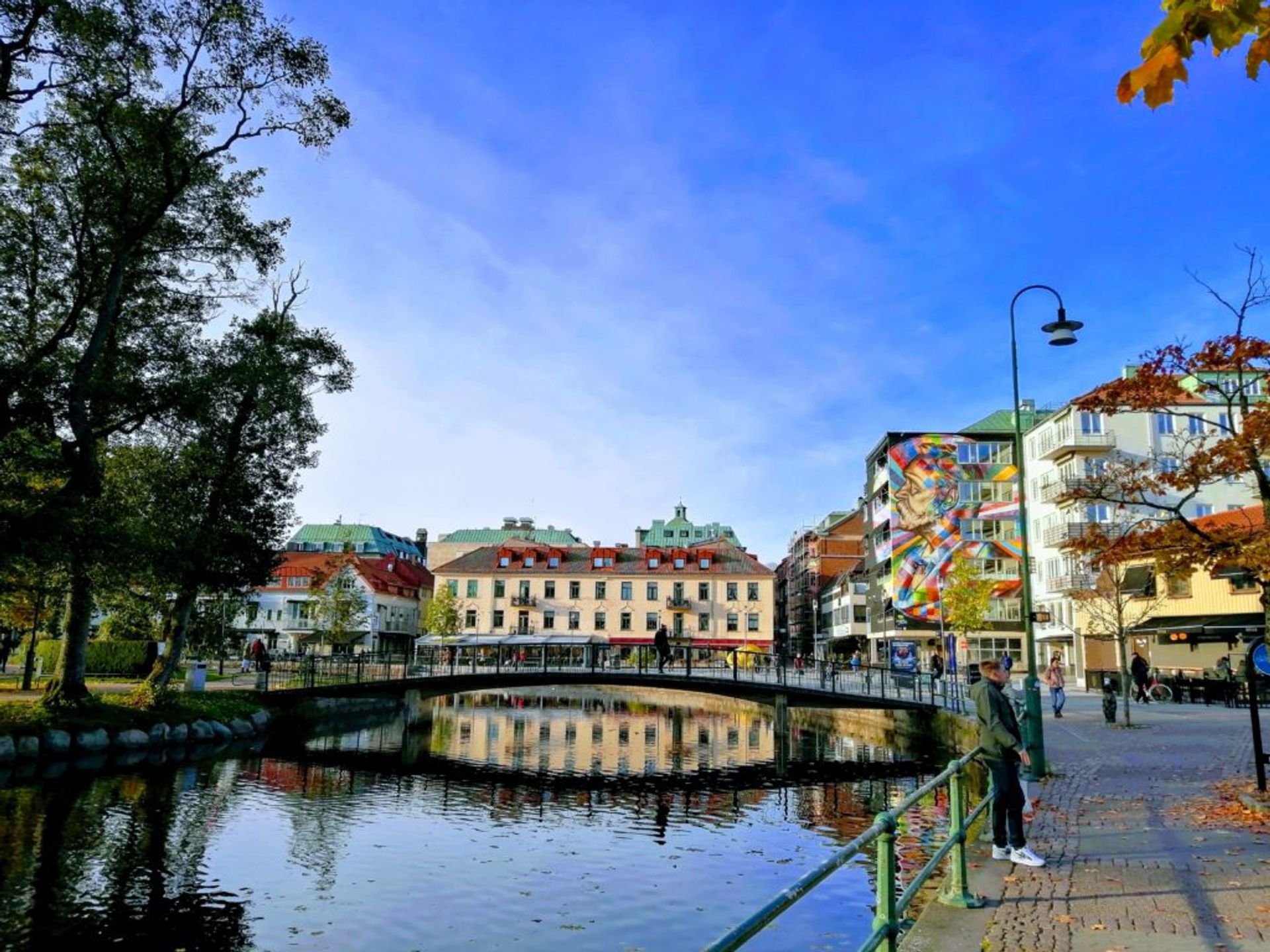 Colourful buildings beside a river.