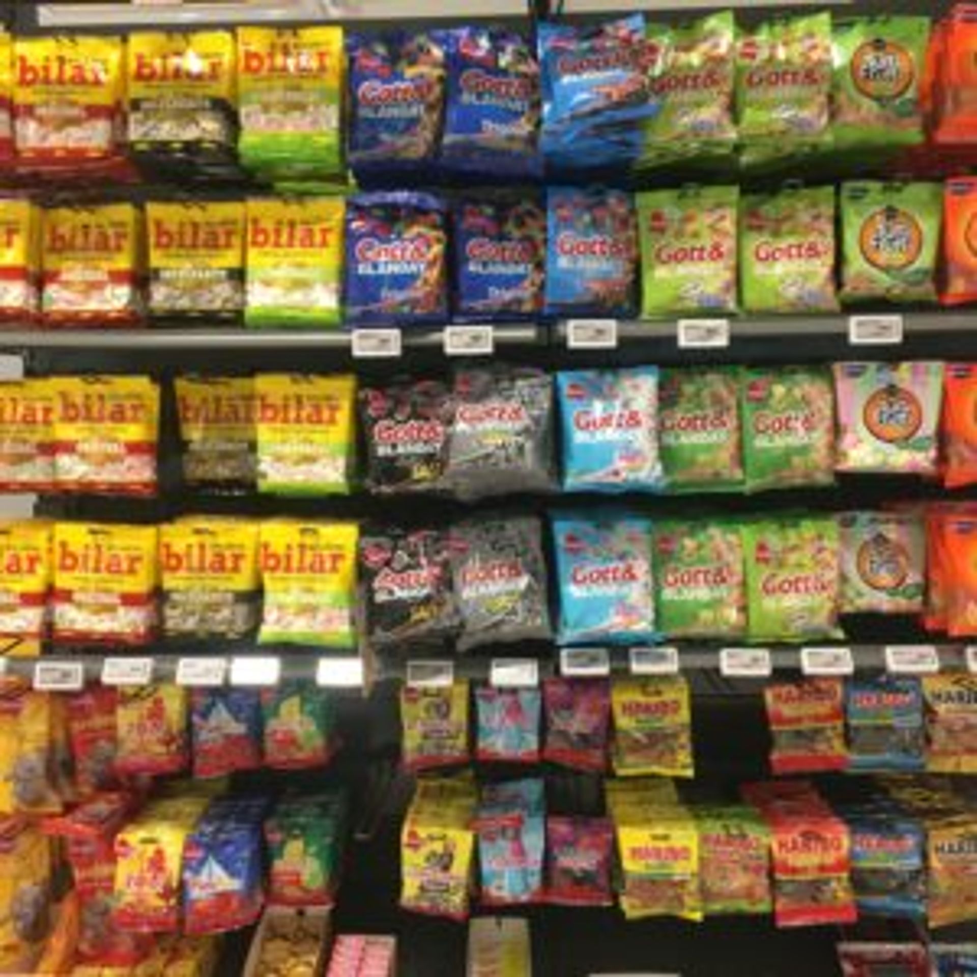 Rows of packets of sweets in a store.