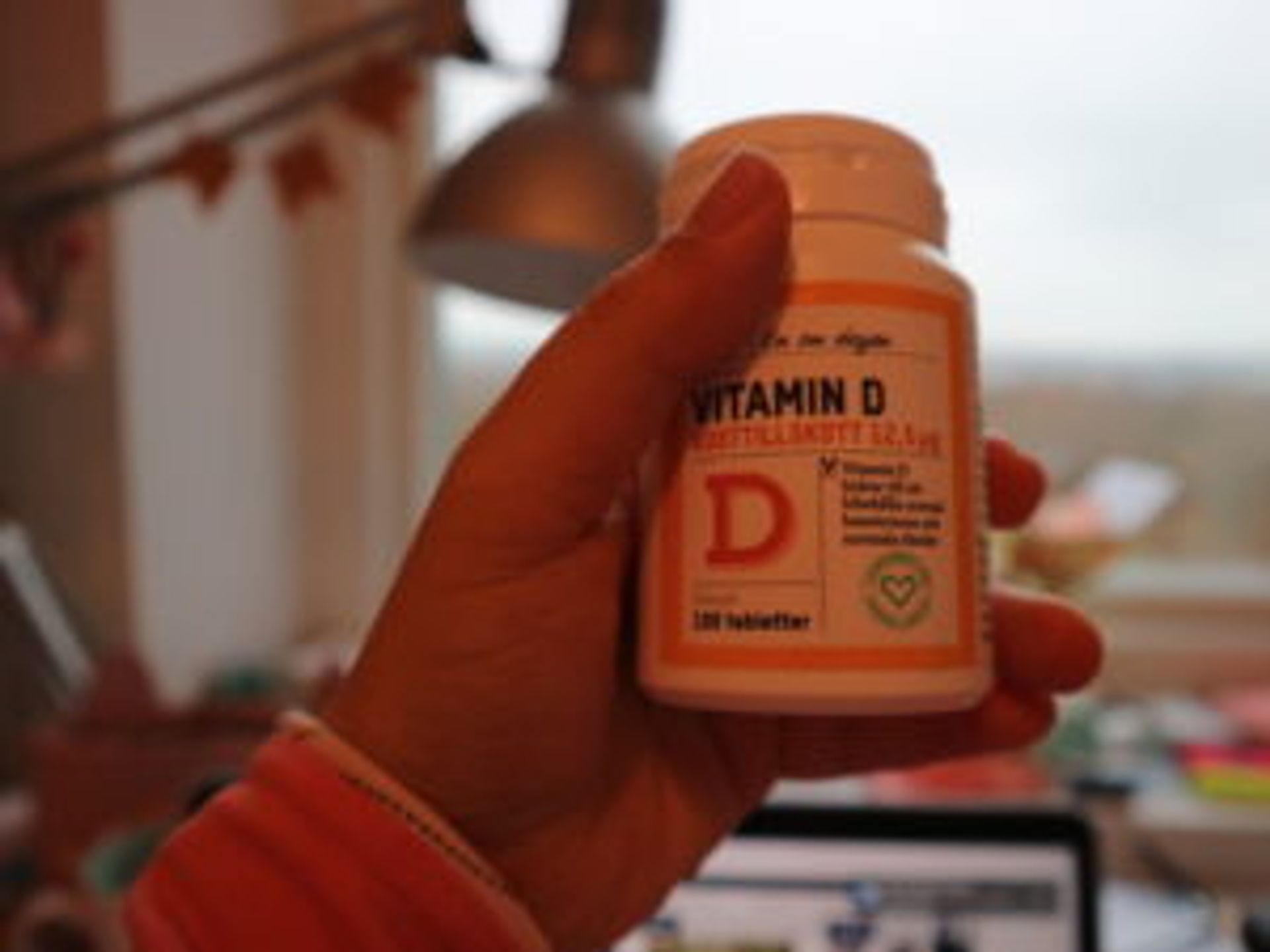 Close-up of a bottle of Vitamin D supplements.
