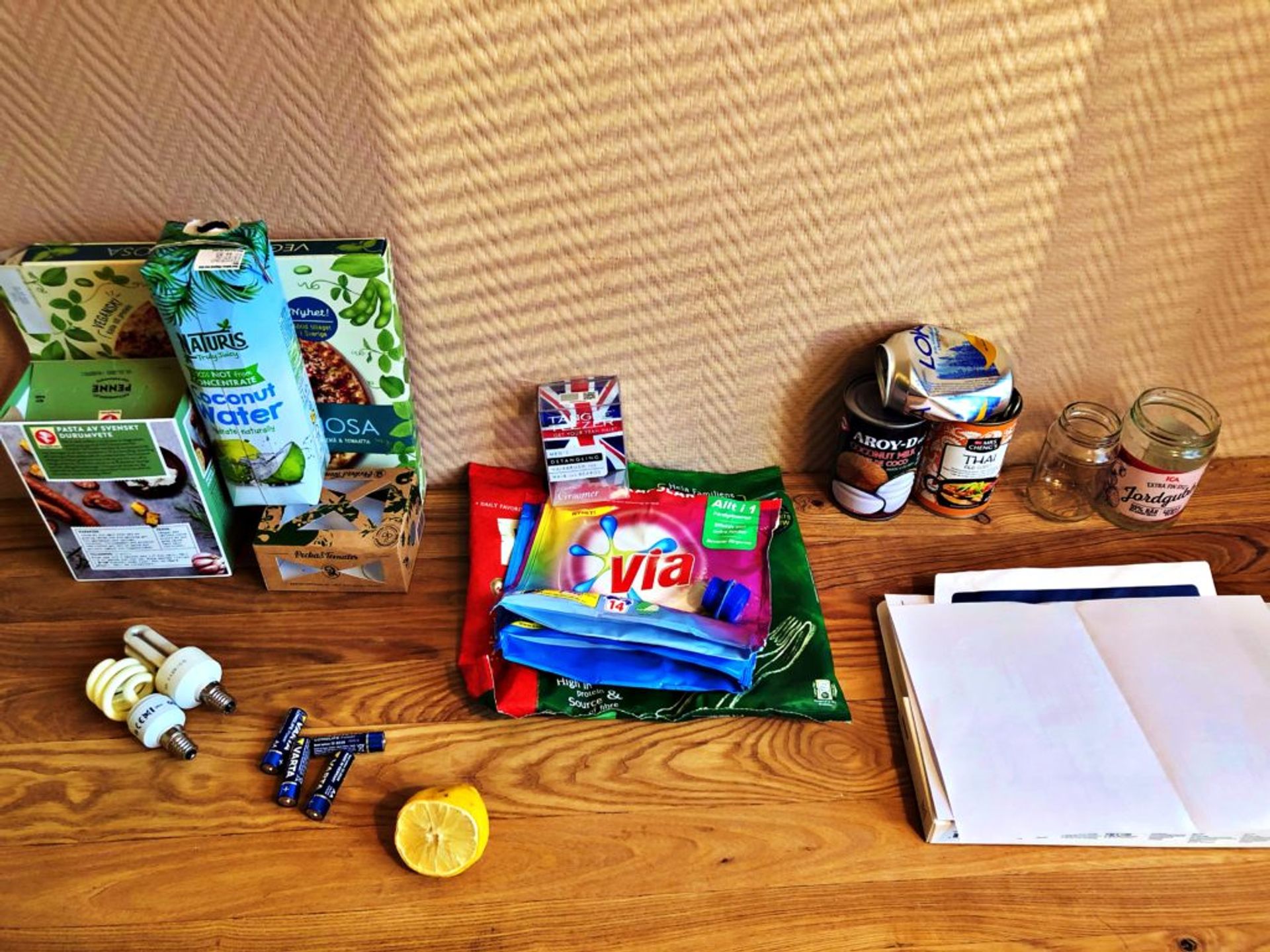 Recycling divided up into piles of paper, plastic, cardboard, cans and glass.