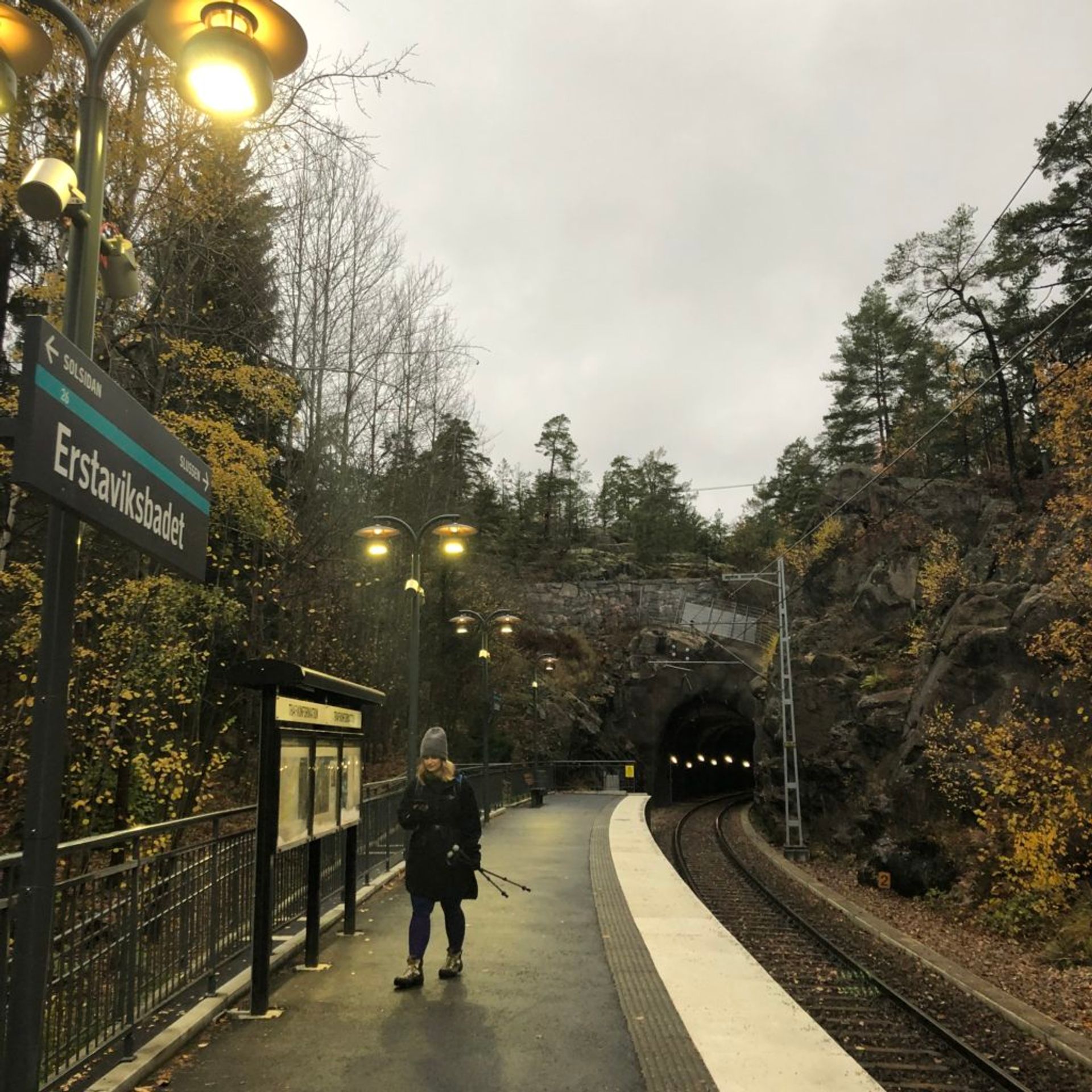 Person standing on a train station platform.