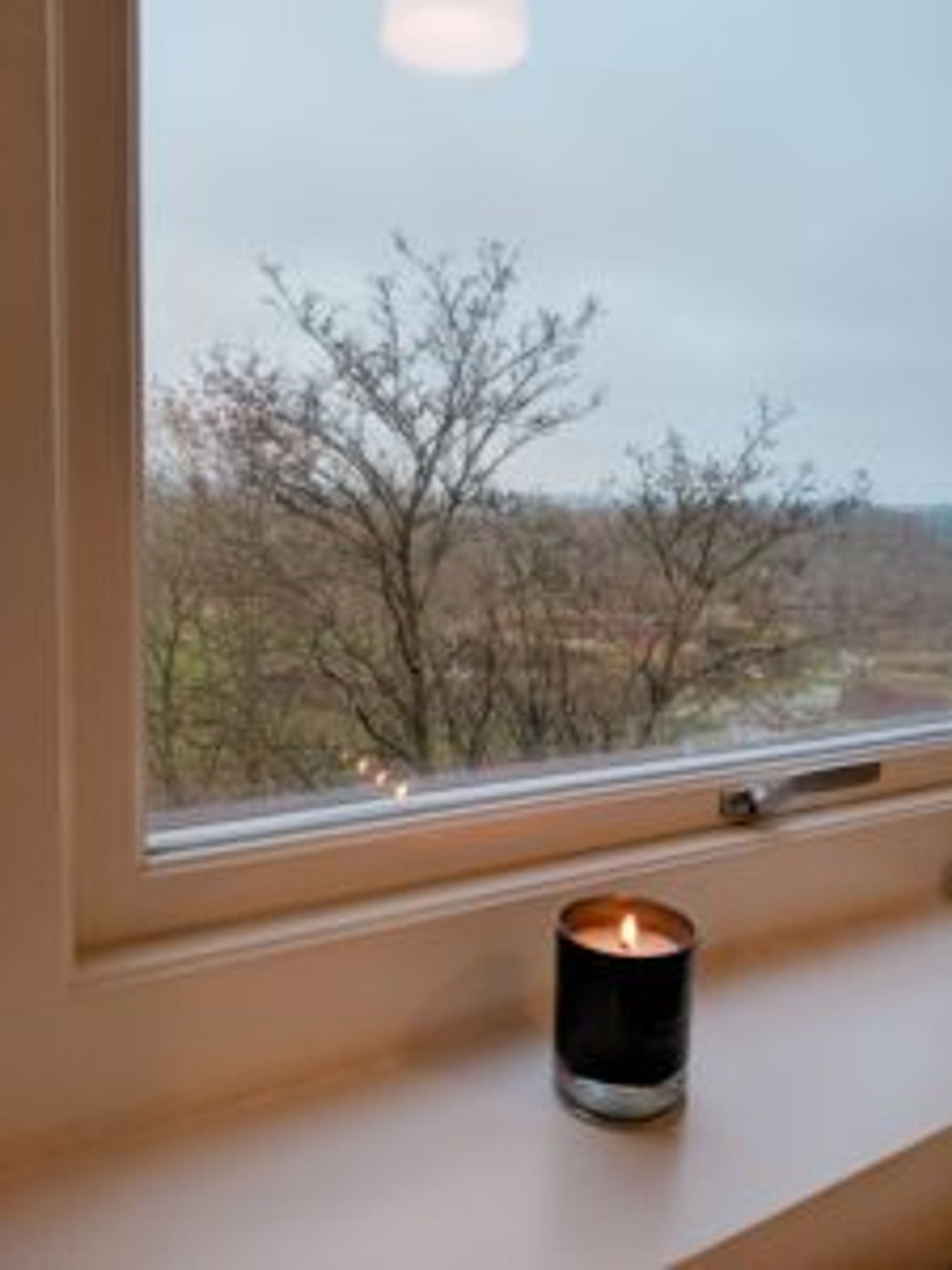 Close-up of a candle on a windowsill.