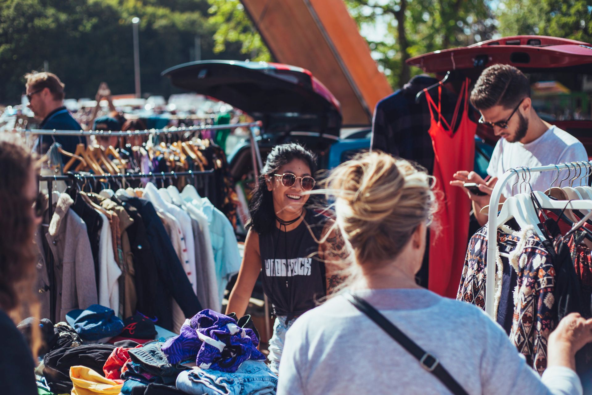 People shopping in an outdoors flea market.