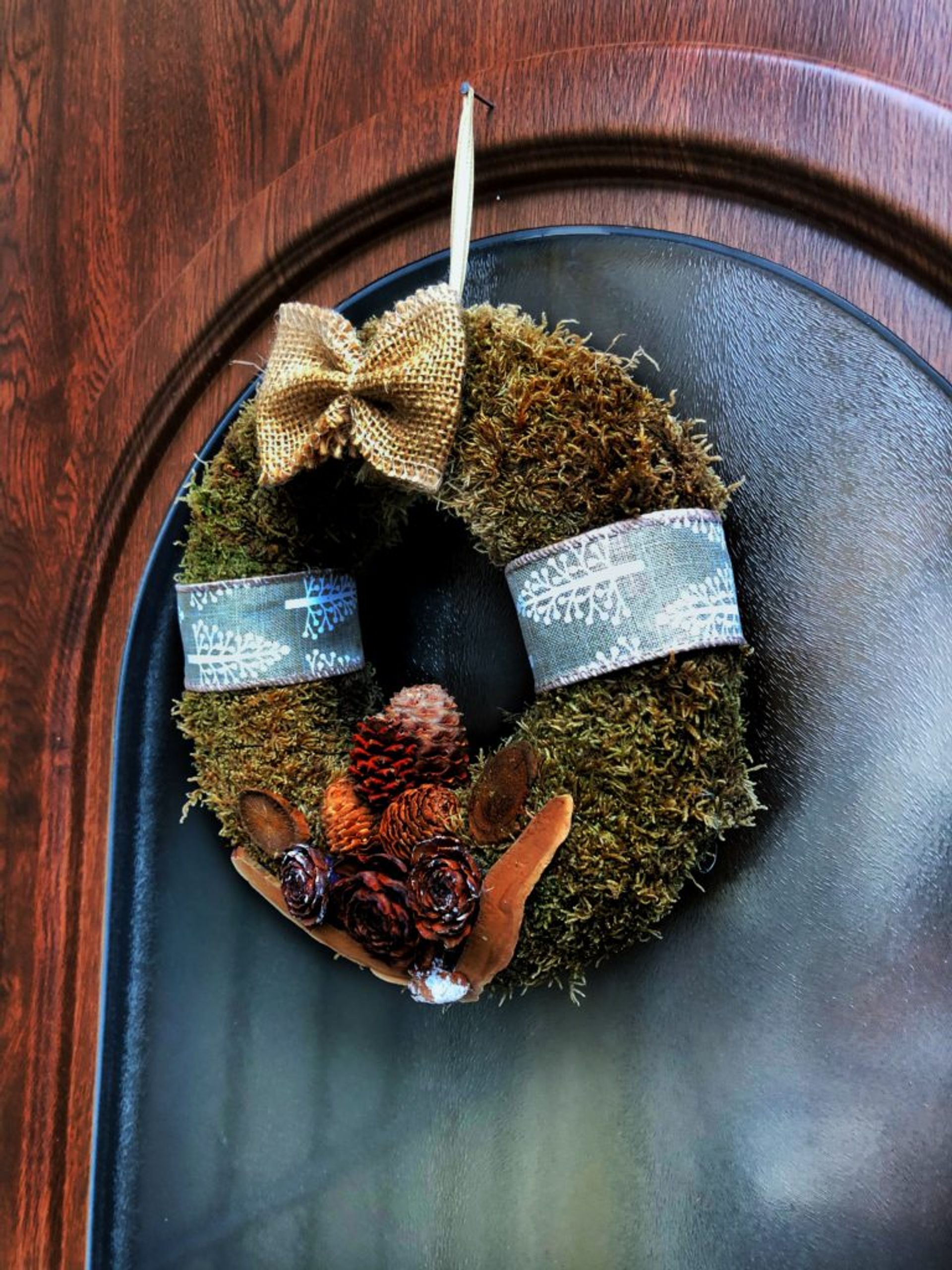 A Christmas wreath hanging on a door.