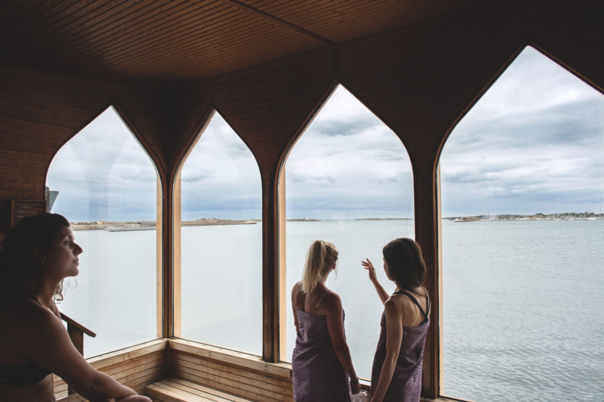 People in a sauna, looking out of the window.