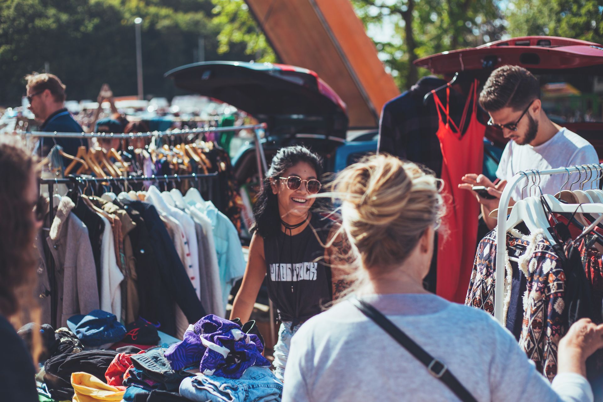 People shopping at an outdoors flea market.