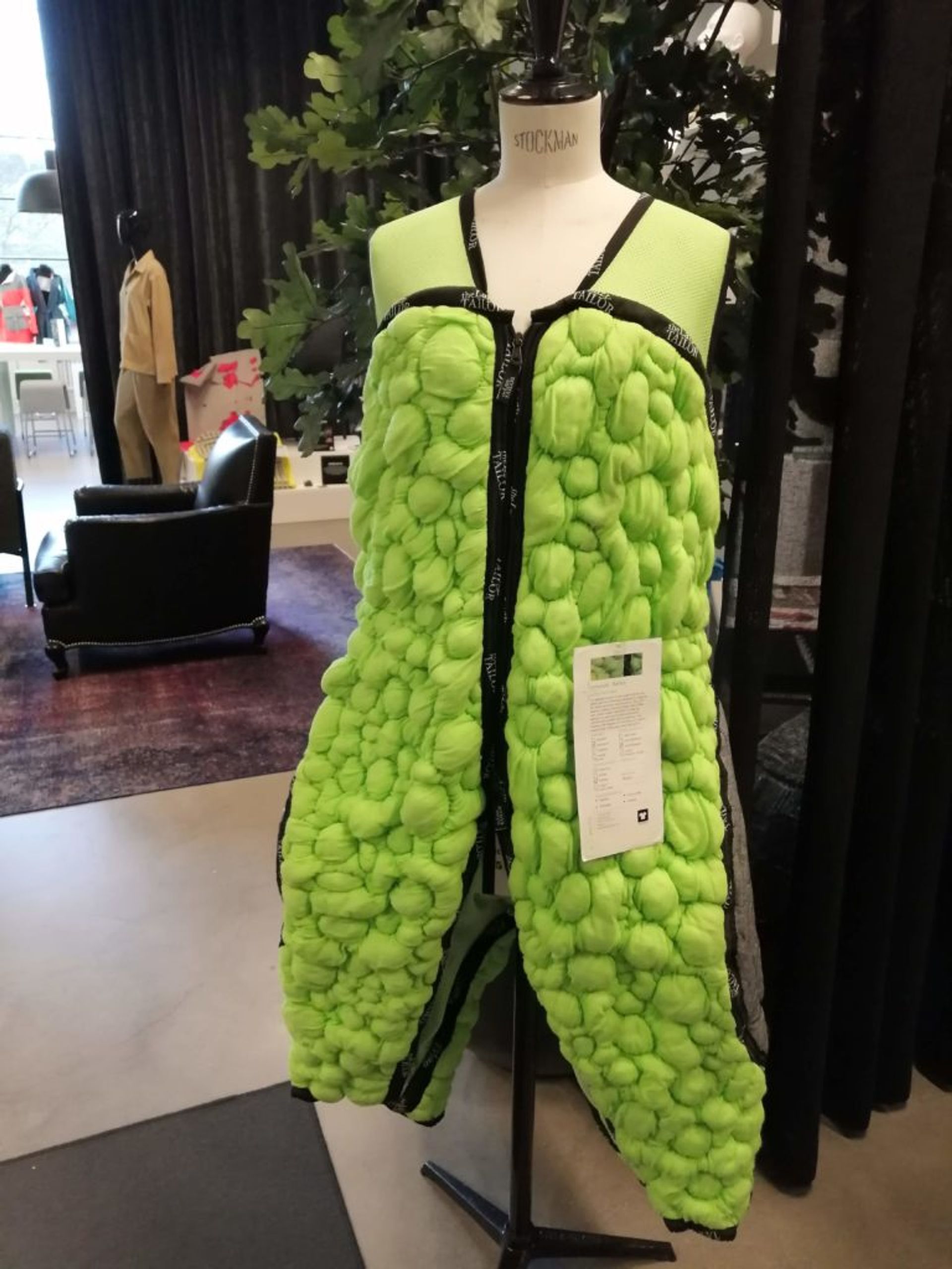 A green, knitted bodysuit in a 3D.