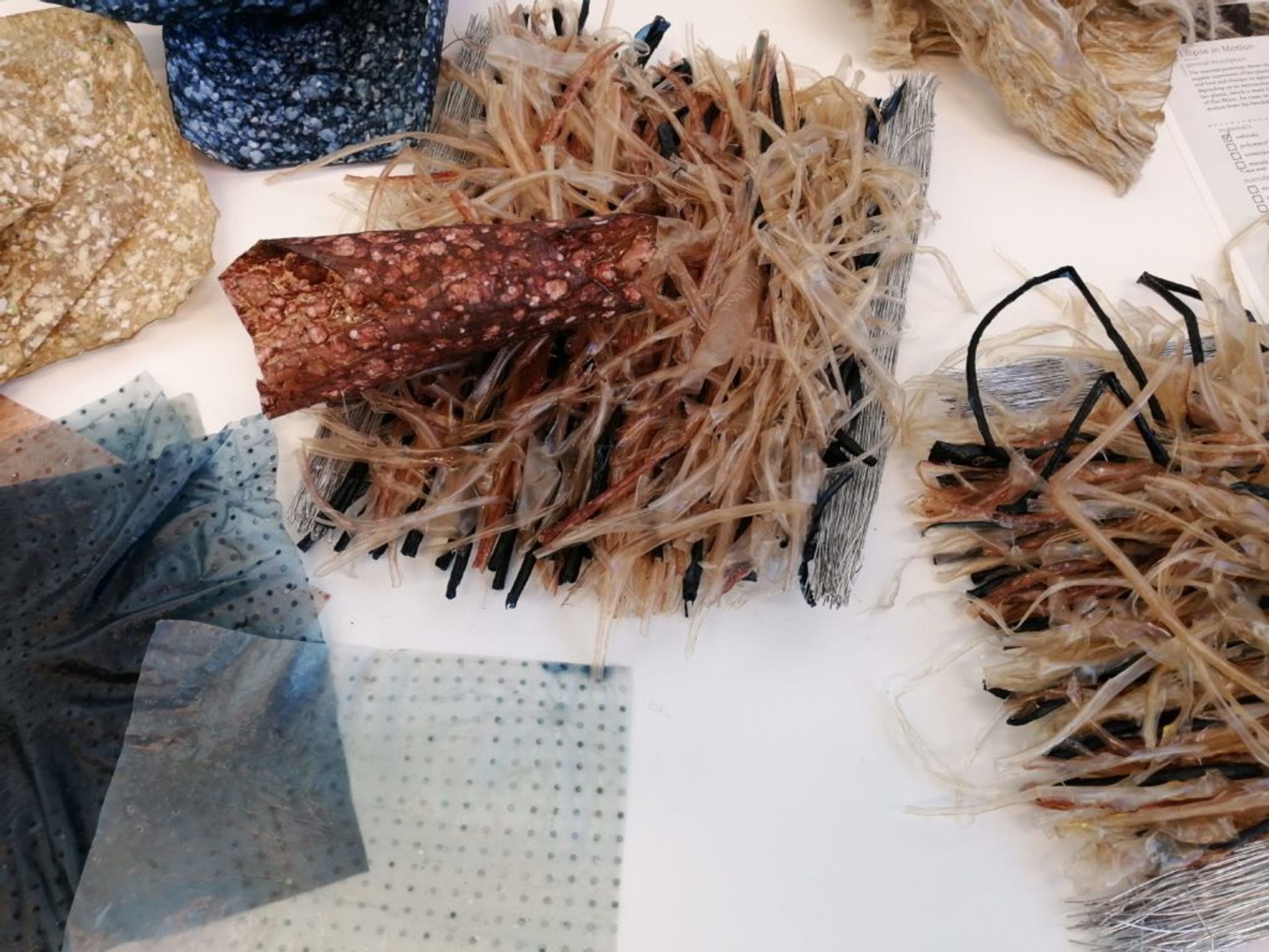 A selection of different textiles made from recycled paper and bio-plastic materials.