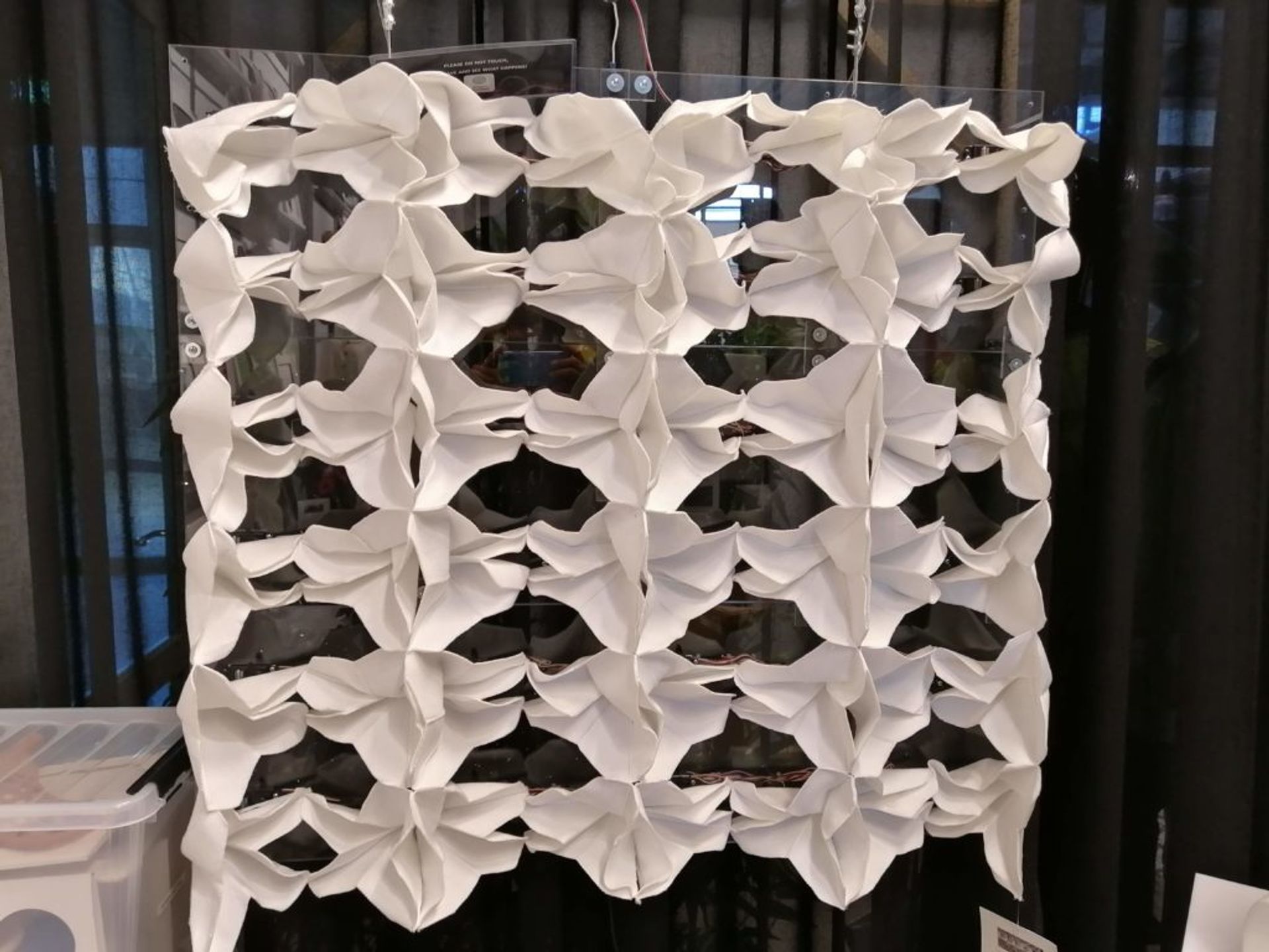 White, knitted textiles attaching to a plastic board.