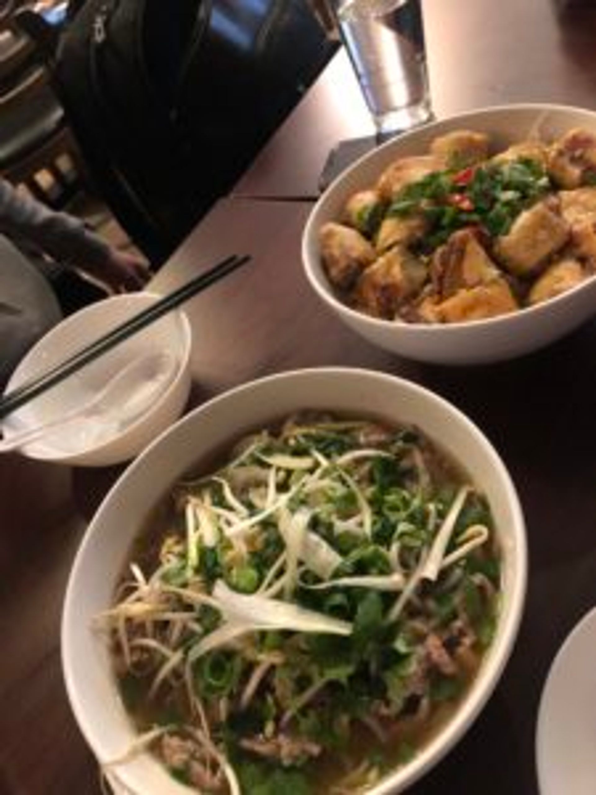 Bowls of Vietnamese food on a table.