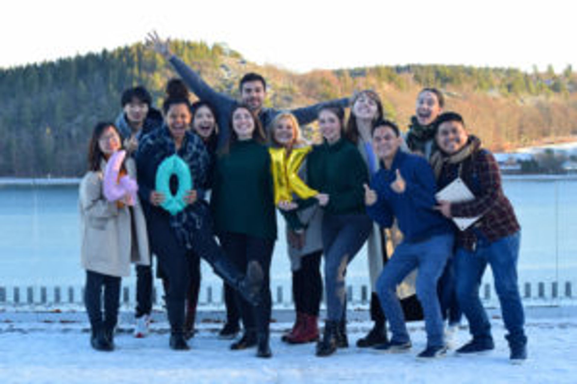 The group of Study in Sweden digital ambassadors standing together in front of a lake.