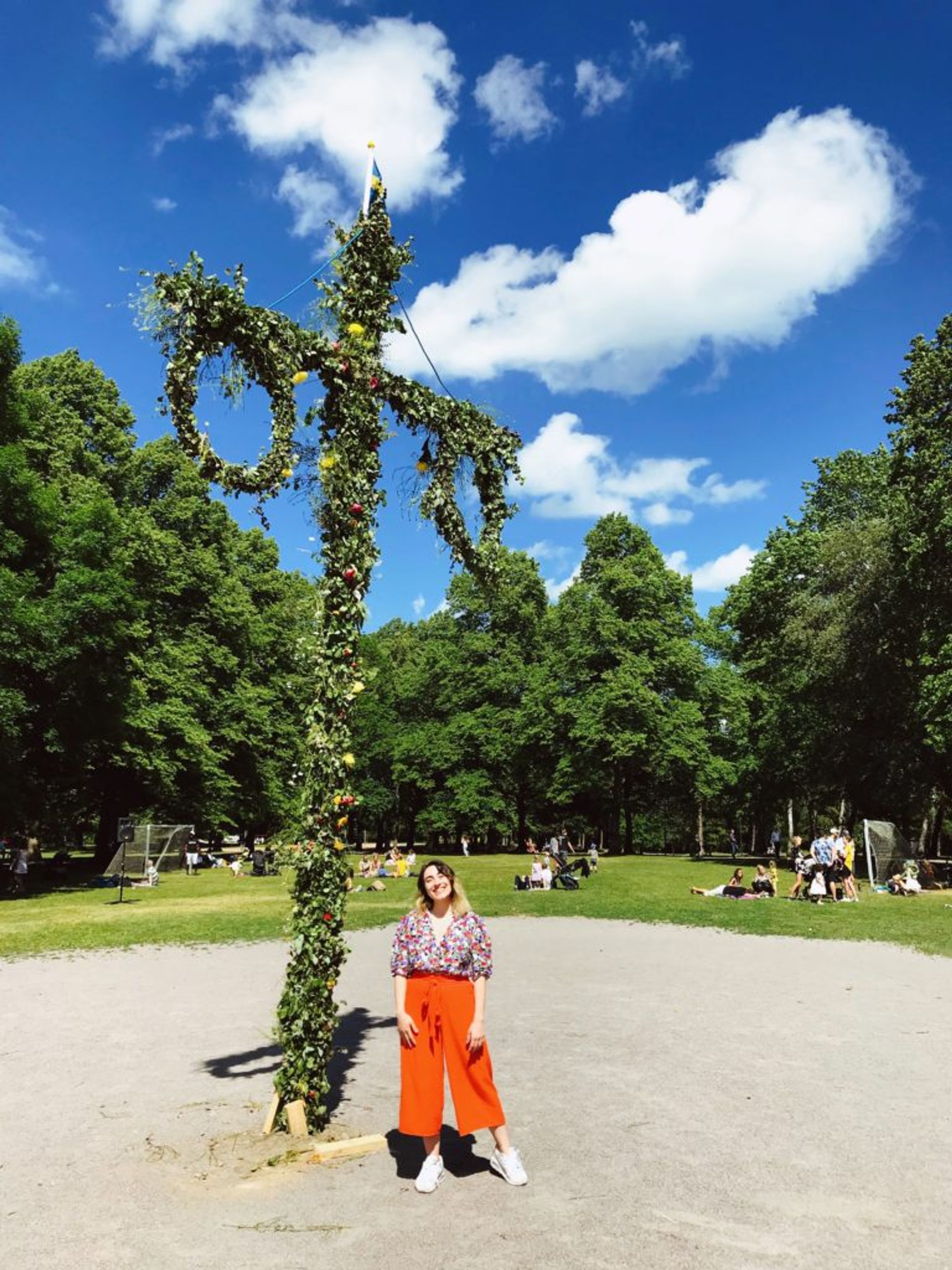 Hazal stands in front of the Midsummer maypole.
