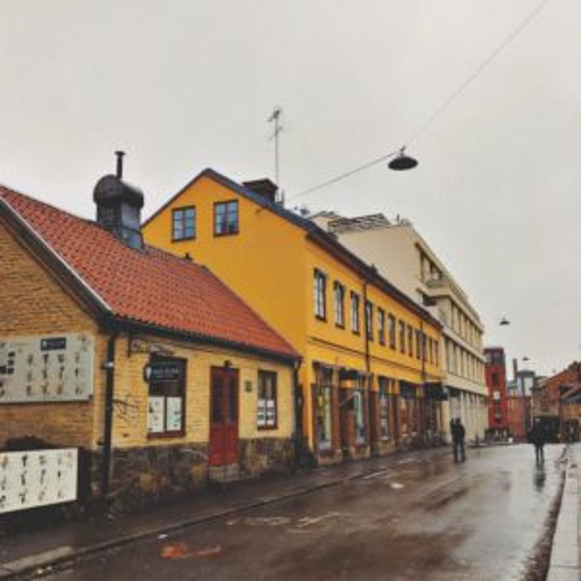 Old, colourful buildings along a road in Norrköping.