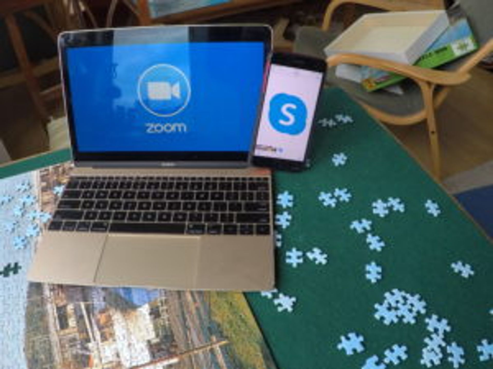 Laptop and phone on a table.