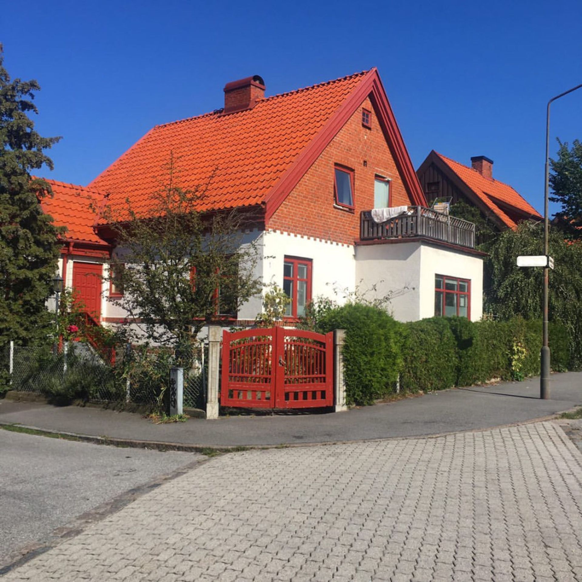 A white and red brick residential house in Malmö.