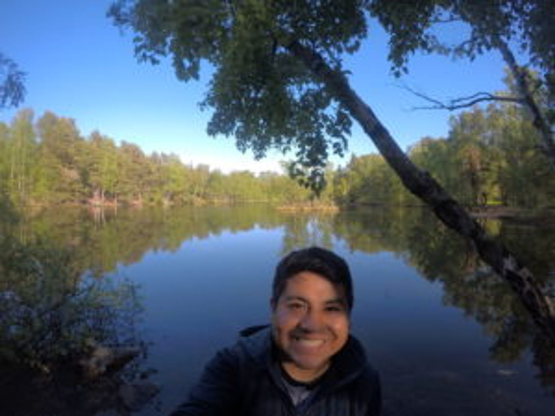 Camilo takes a selfie in front of the lake.