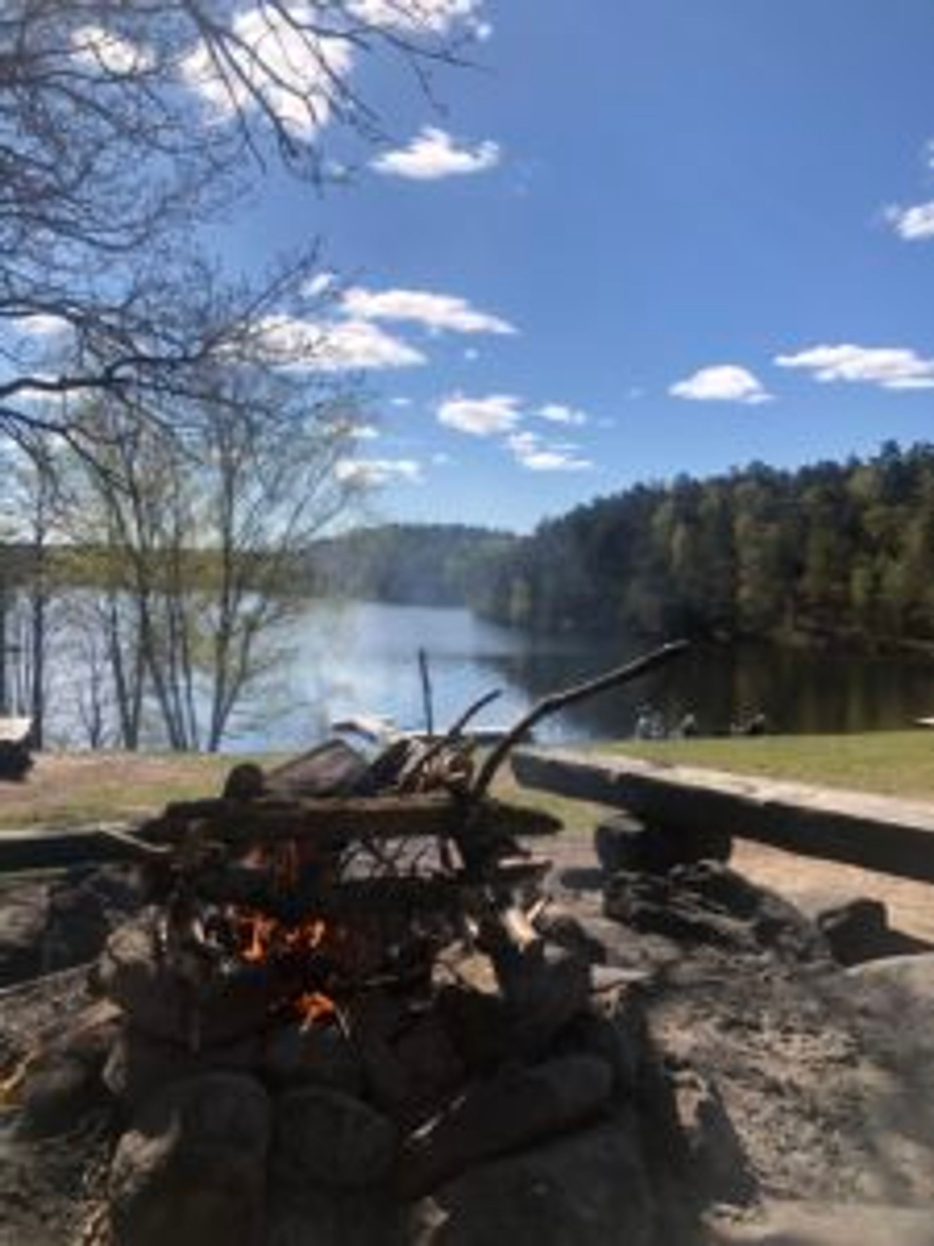 A small campfire by a lake.