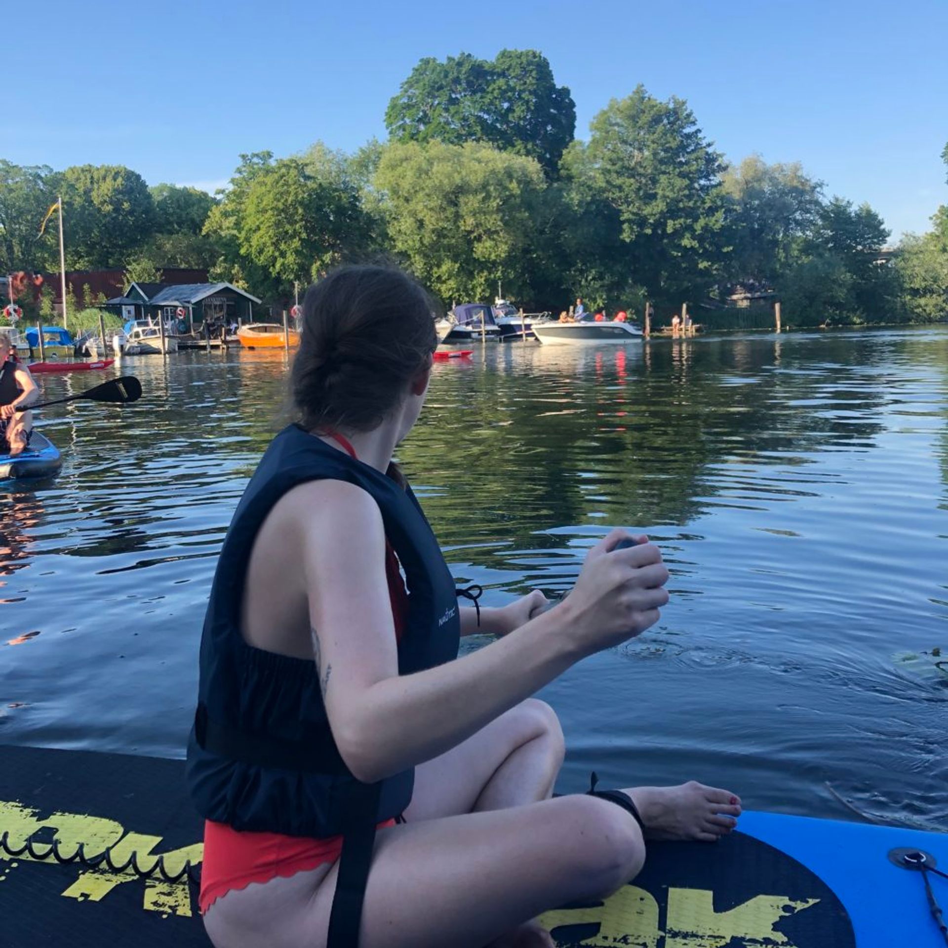 Emma paddleboards in Stockholm.