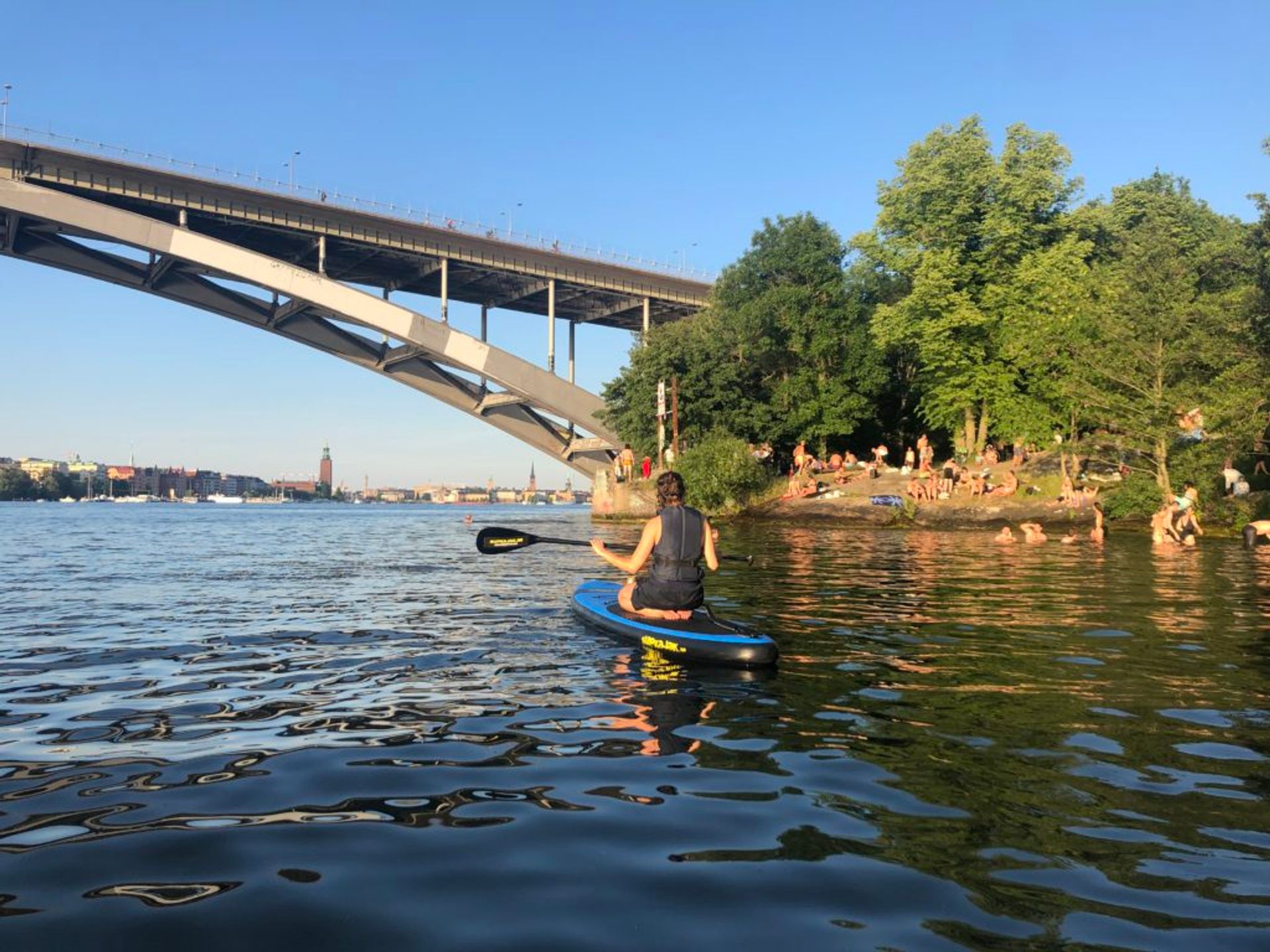 A person paddleboarding in the sea close to Stockholm city centre.