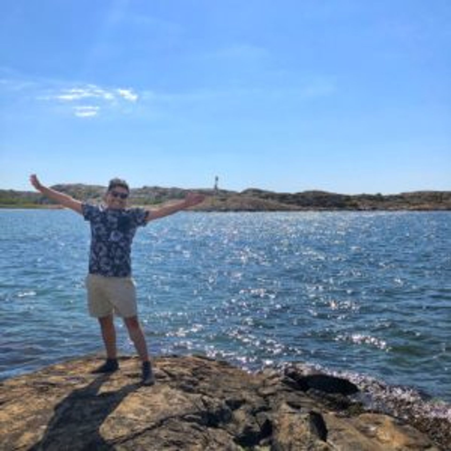 Camilo stands in front of the sea.