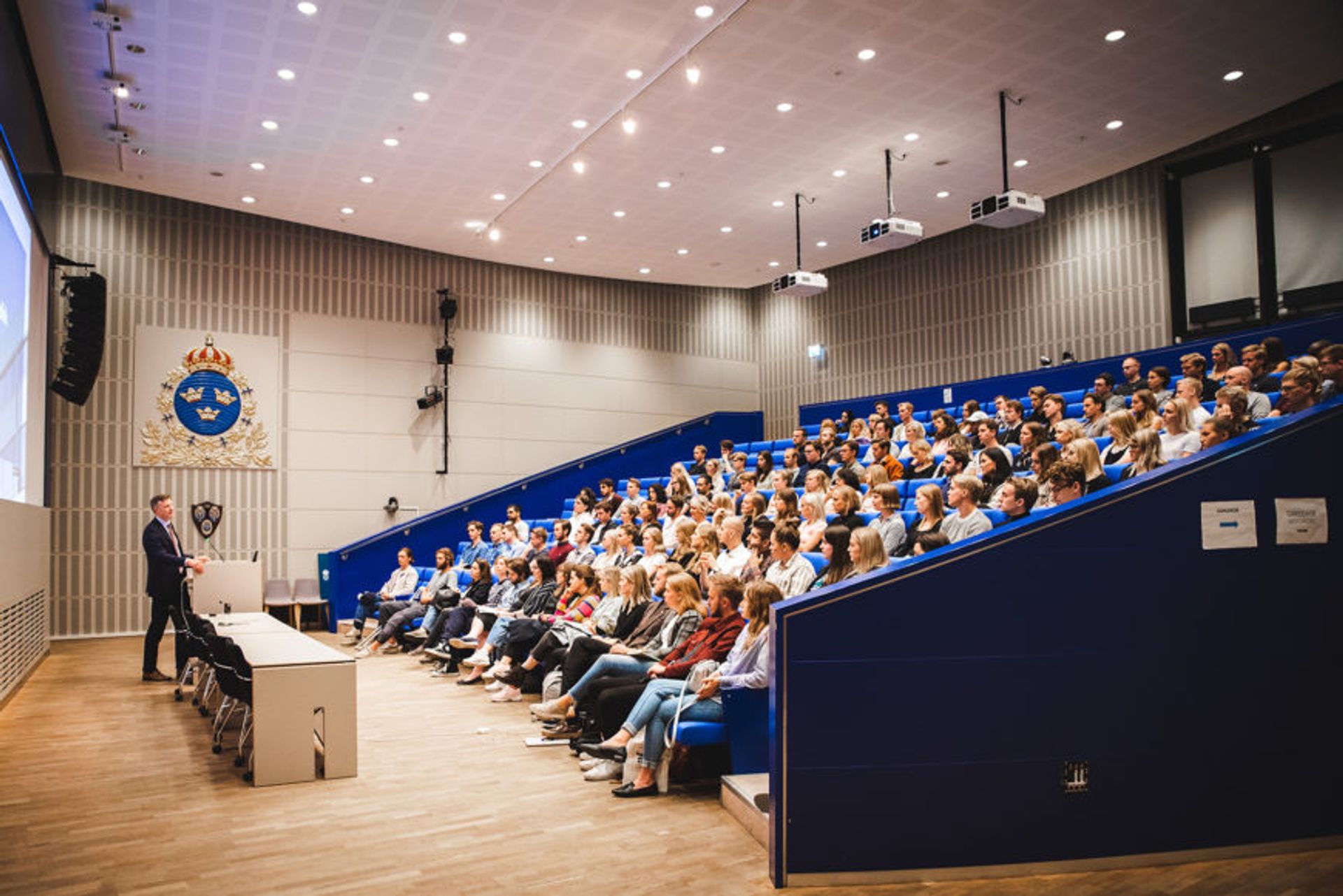 A lecture hall at Sweden defence university, full with students.