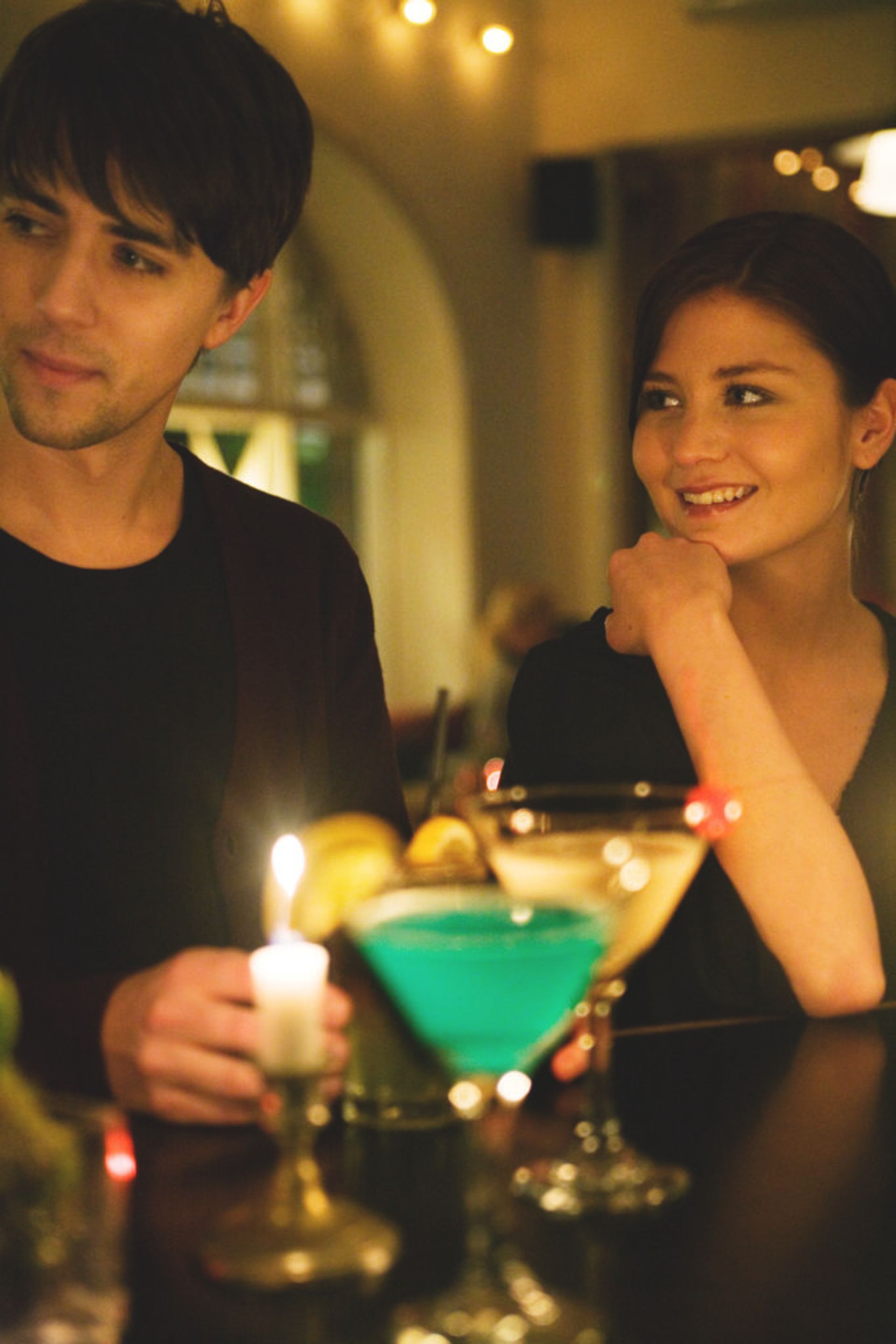 A man and woman having a date at a bar.