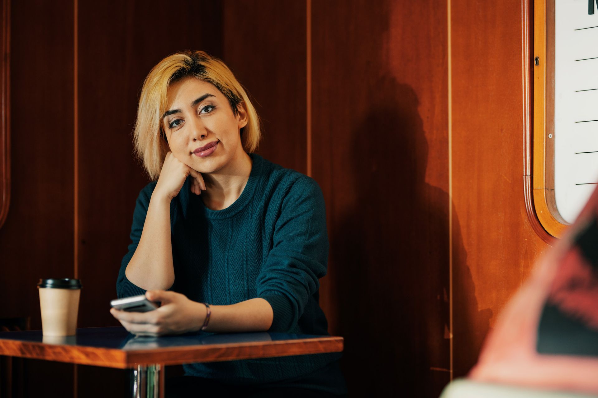 International student from Iran sitting in a cafe in Sweden