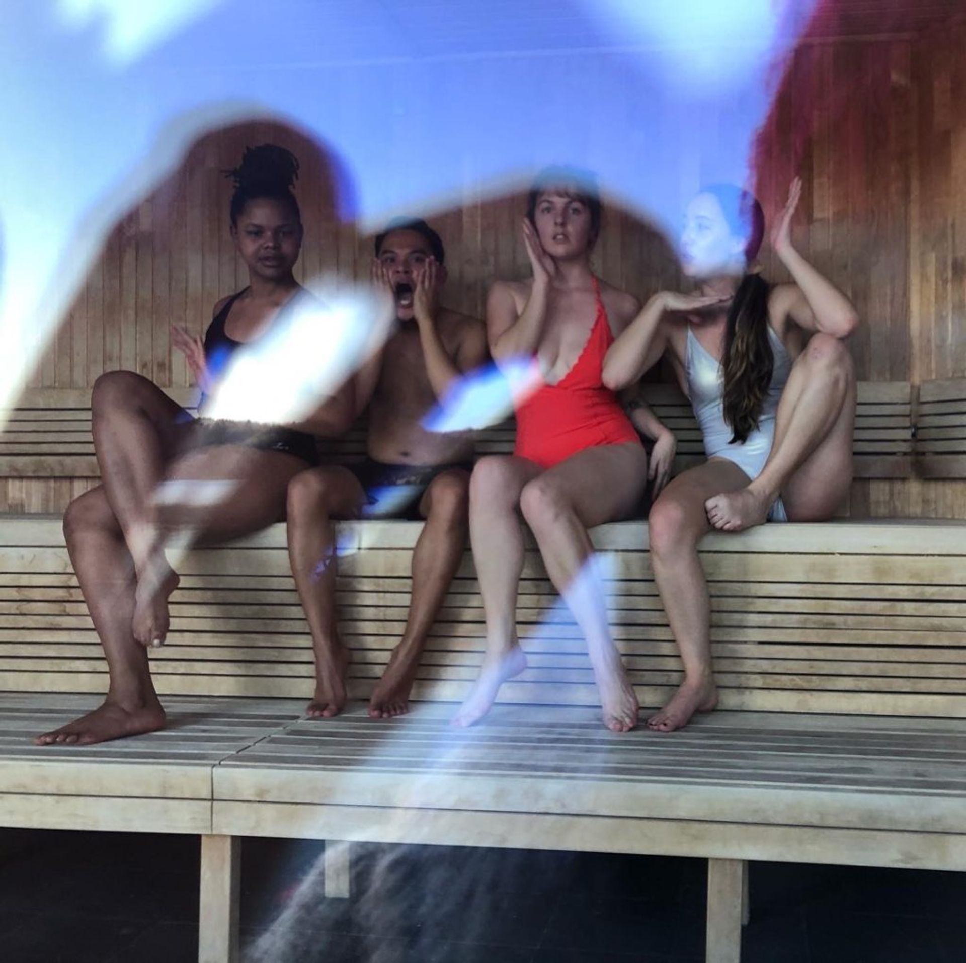 Four students sitting in a sauna.