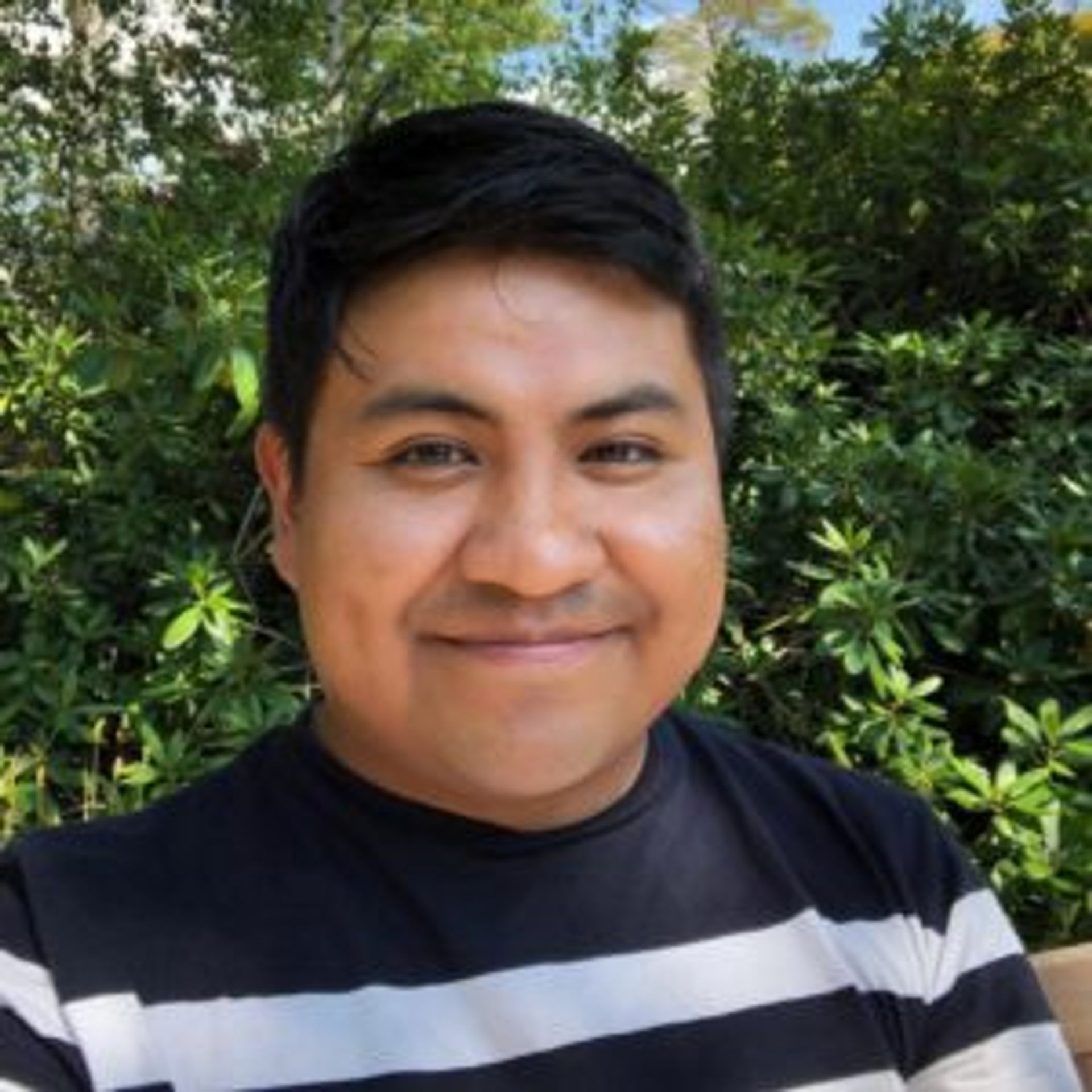 Camilo wearing a black and white stripy jumper.