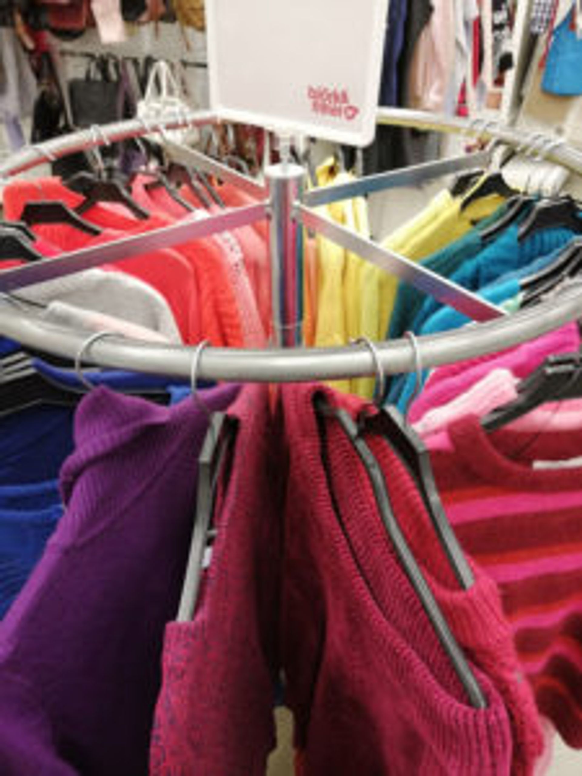 Rack of colourful sweaters at Emmaus Borås