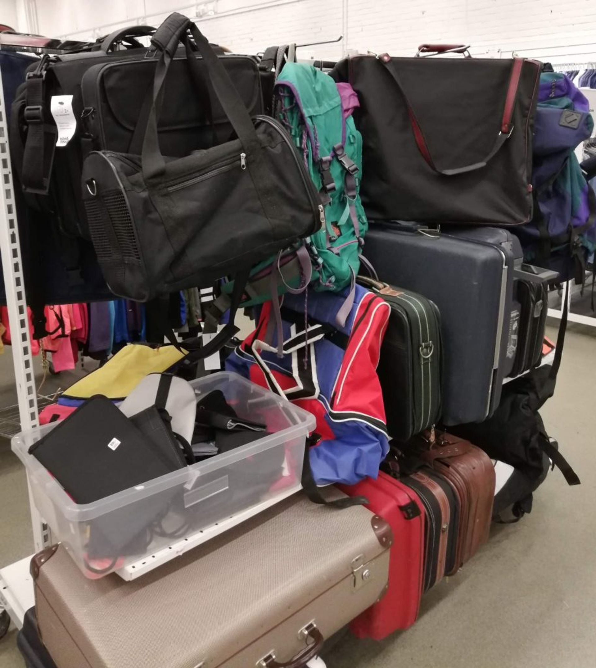 Shelves of suitcases, laptop bags and rucksacks. 