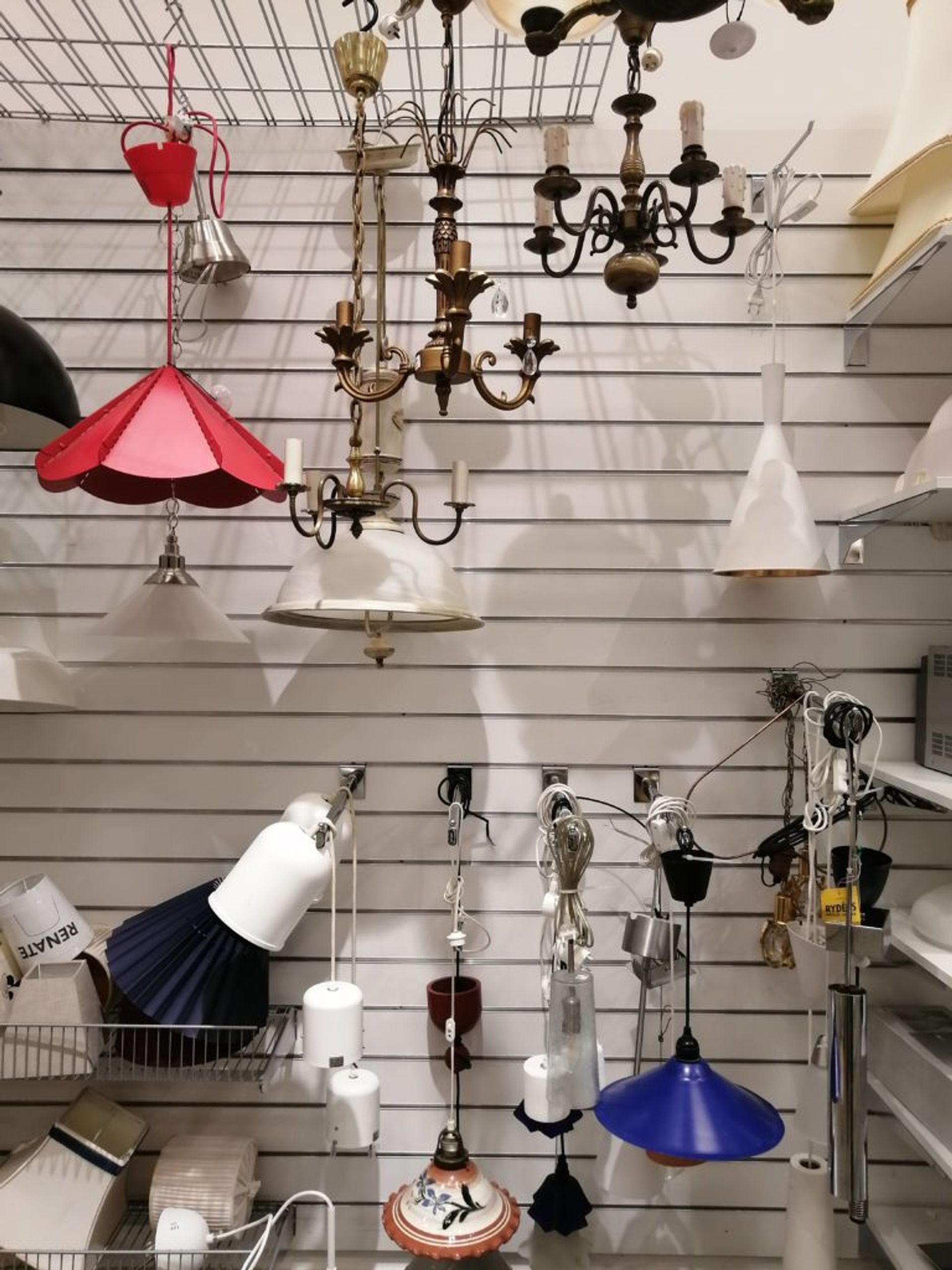Racks and shelves of light fittings and lampshades.