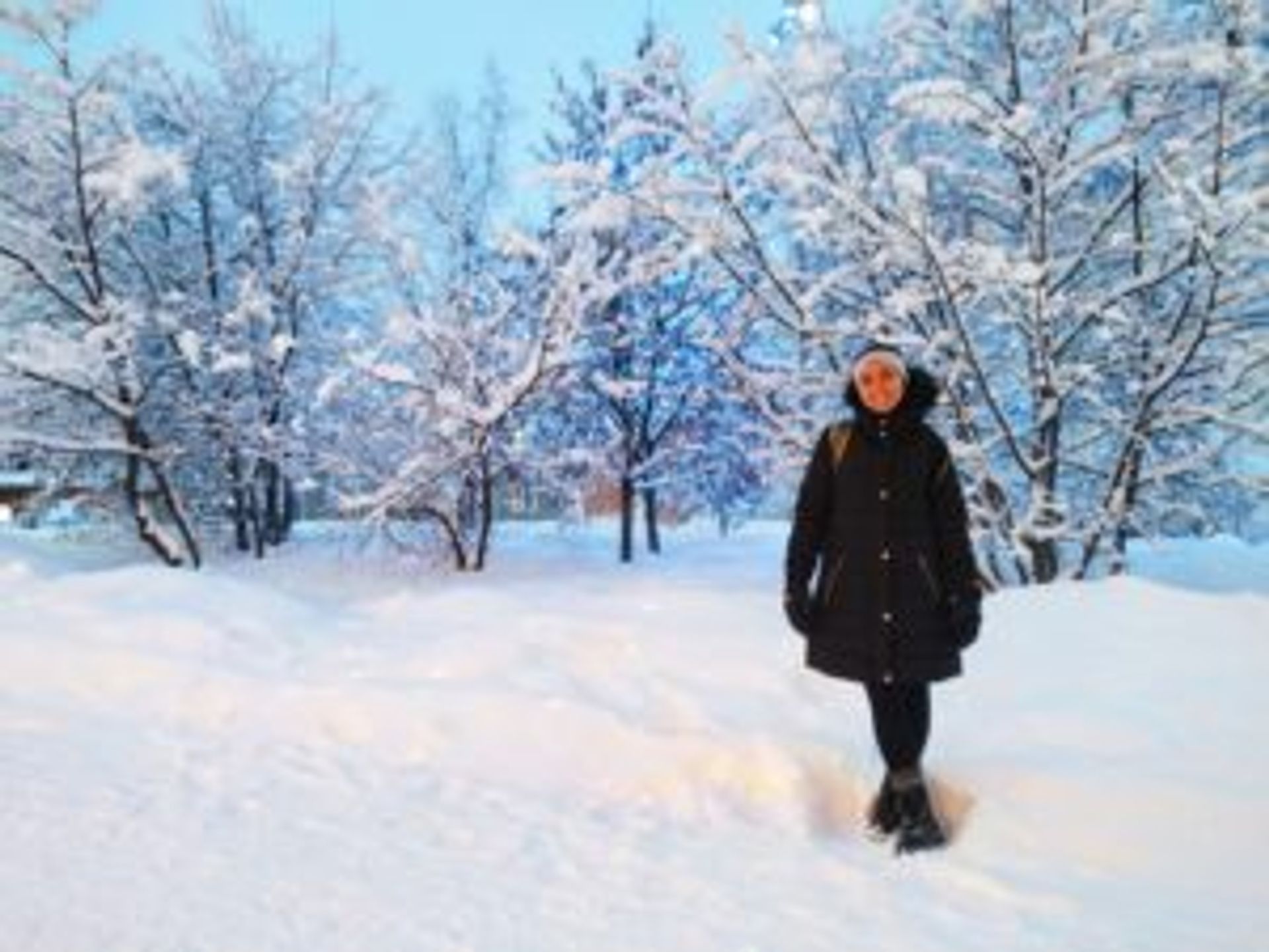 Maria standing in a snowy park.